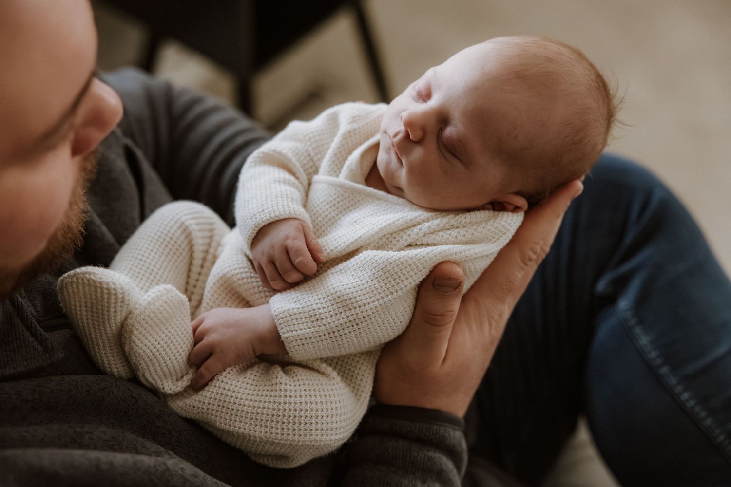 A series of intimate shots showing peaceful moments with a baby in white knit clothing.