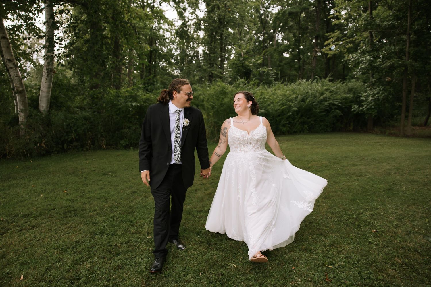Wedding couple sharing a romantic moment in a scenic wooded area.