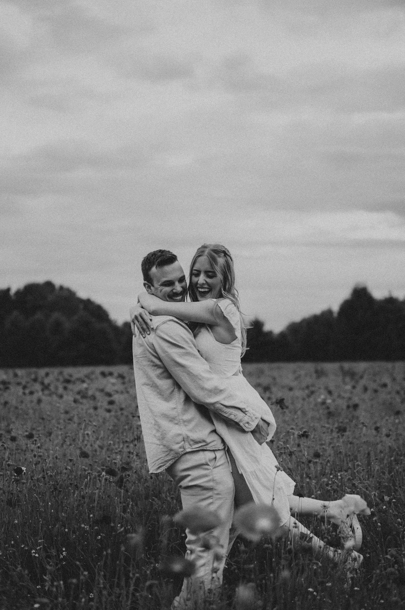 Playful moment captured in a field of wildflowers on an overcast day.