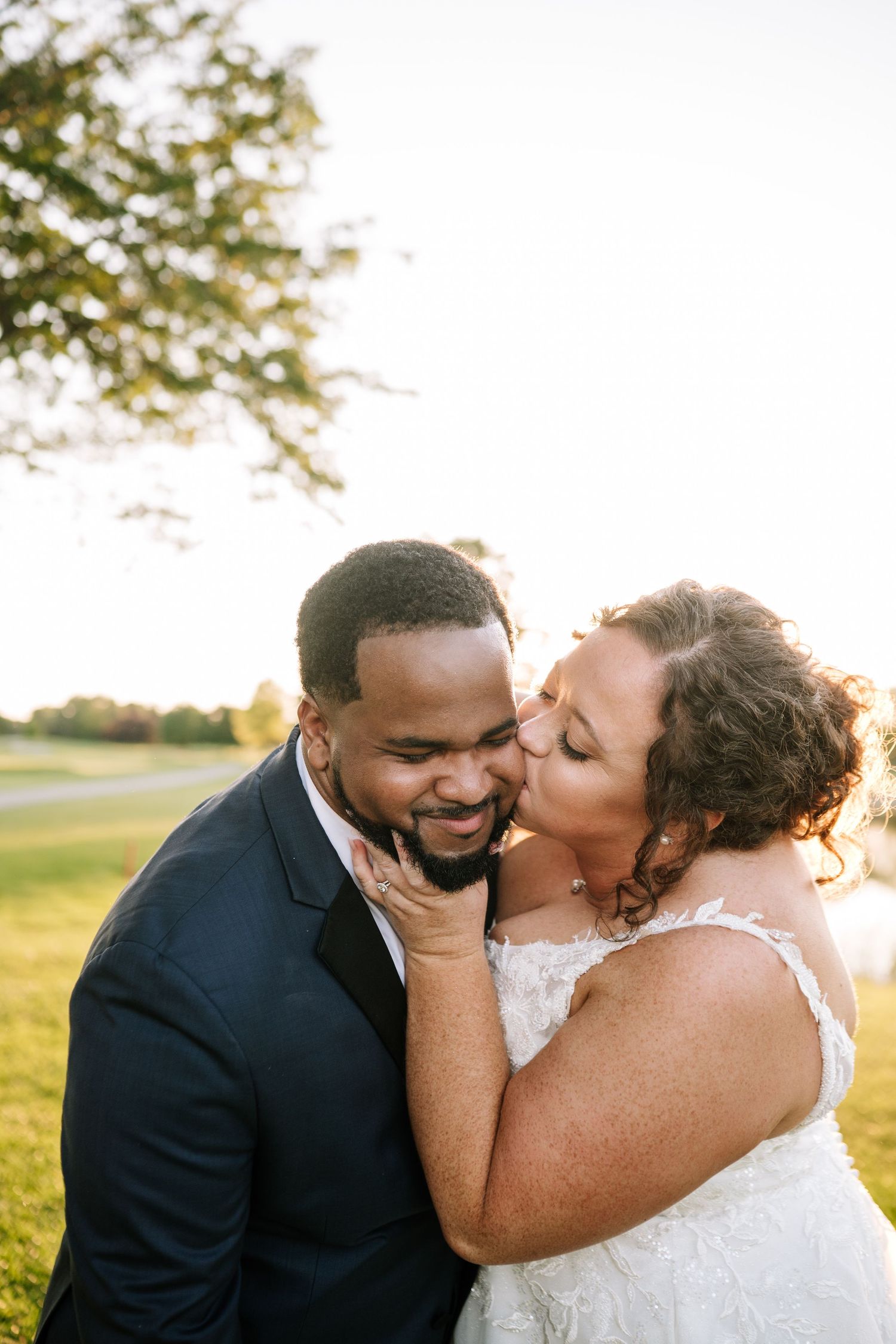Intimate wedding couple portrait captured during golden hour.