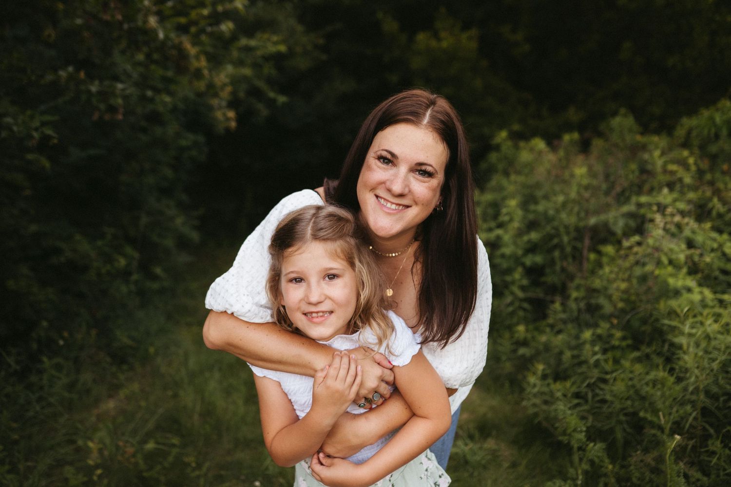 A warm summer evening portrait session in a garden with matching white outfits.
