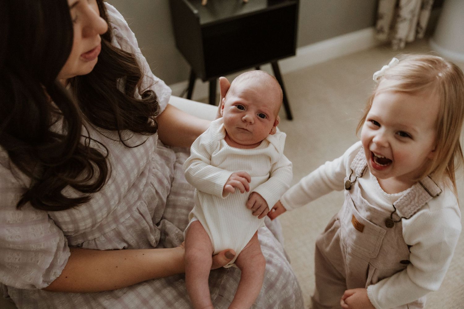 A heartwarming series of candid family moments showing tender interactions between mother and children at home.