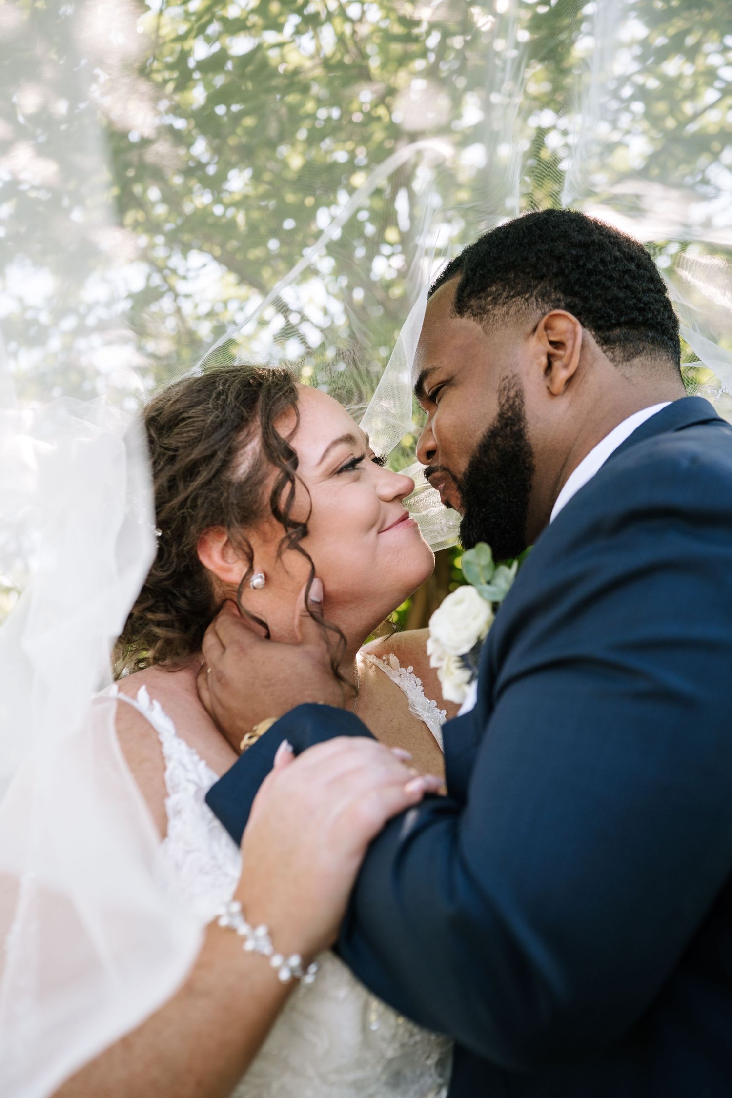 Romantic wedding couple sharing intimate moments during their outdoor photo session.