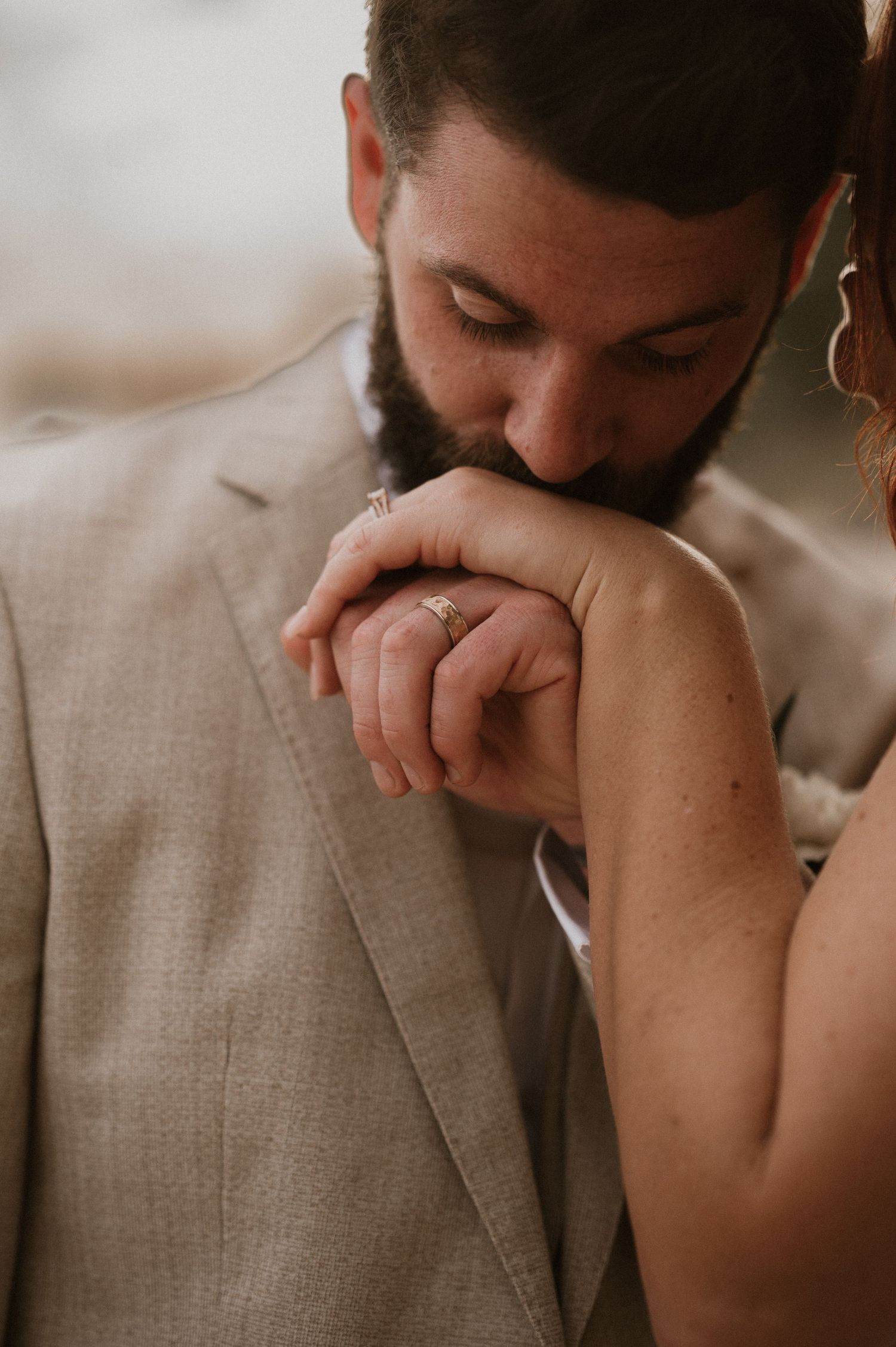 Intimate moment captured with gentle hand gesture in soft lighting.