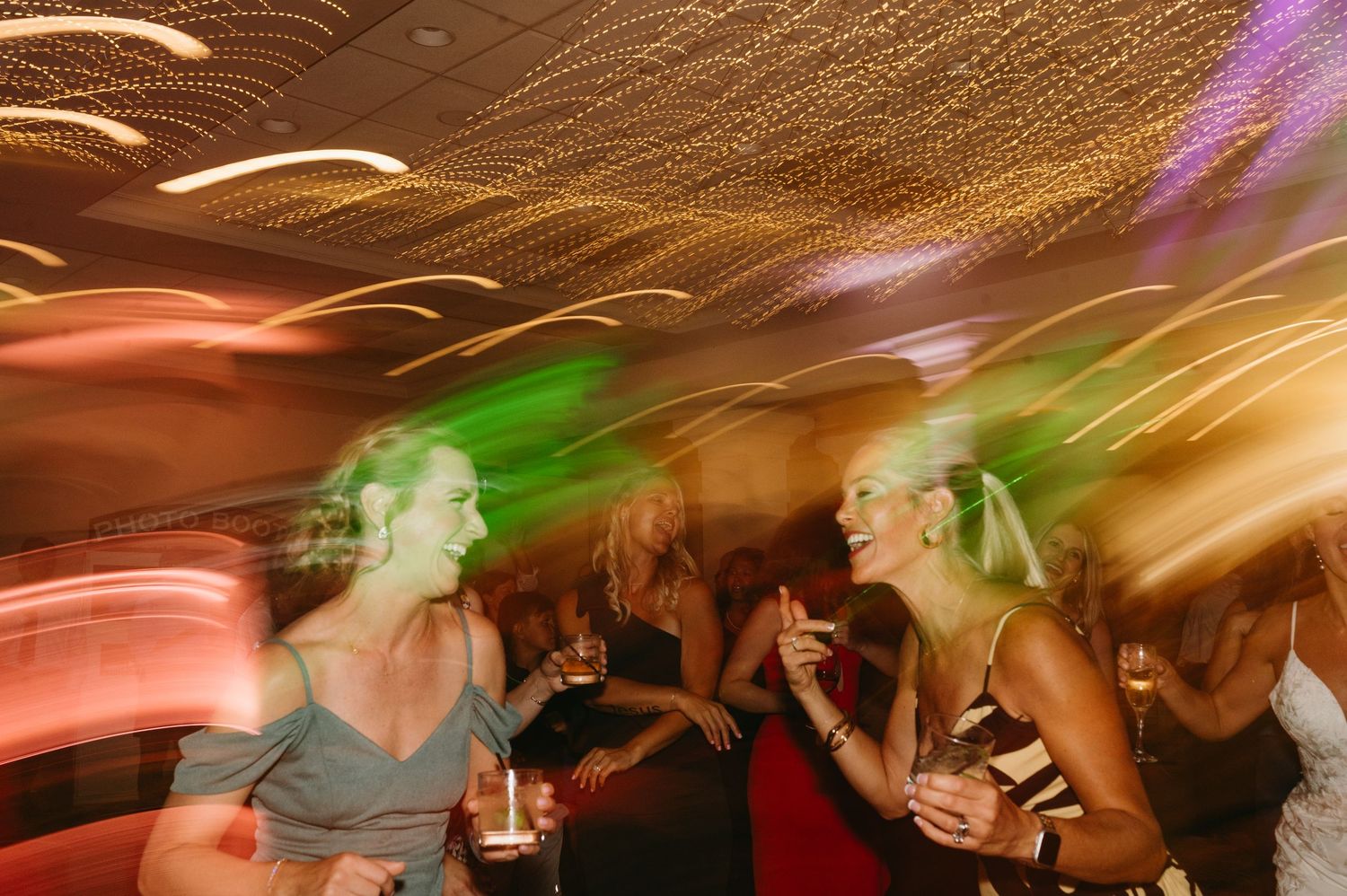 Abstract motion blur photograph of colorful lights and movement at a nighttime celebration.