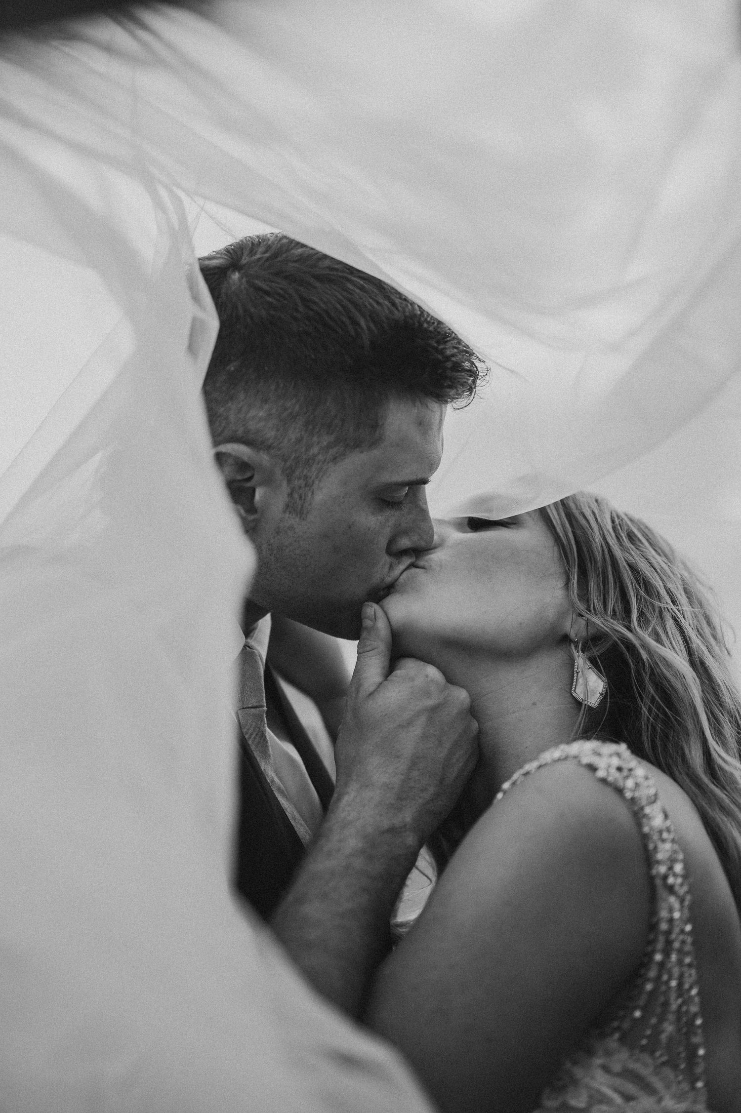 Romantic black and white wedding moments captured through sheer veil.
