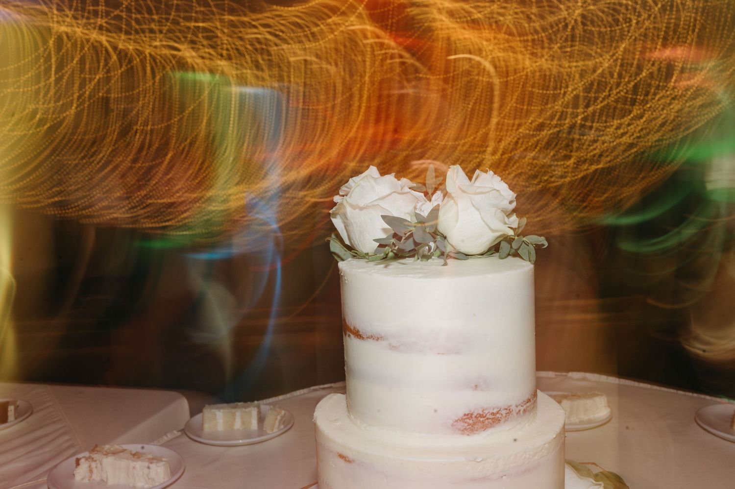 Long exposure photo creating light trails and motion blur effects at a wedding reception.