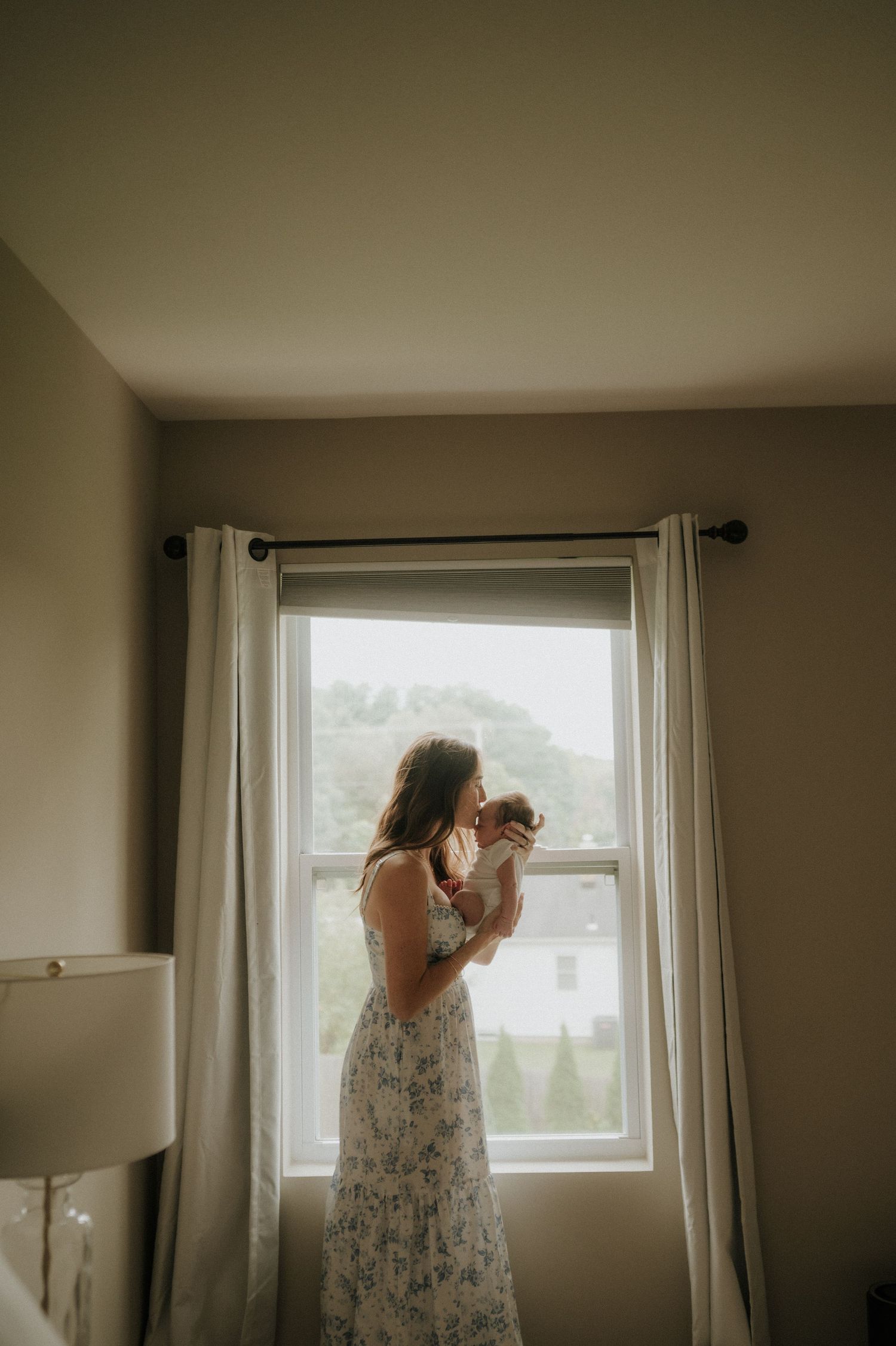 Moody indoor photography sequence showing silhouette against bright window light.