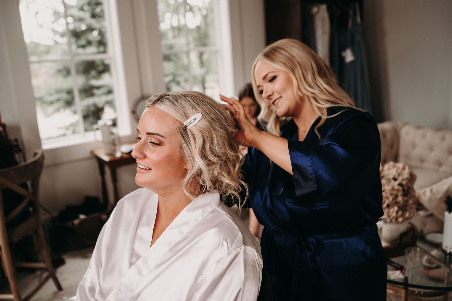 Wedding day preparation scene with hair styling in progress.