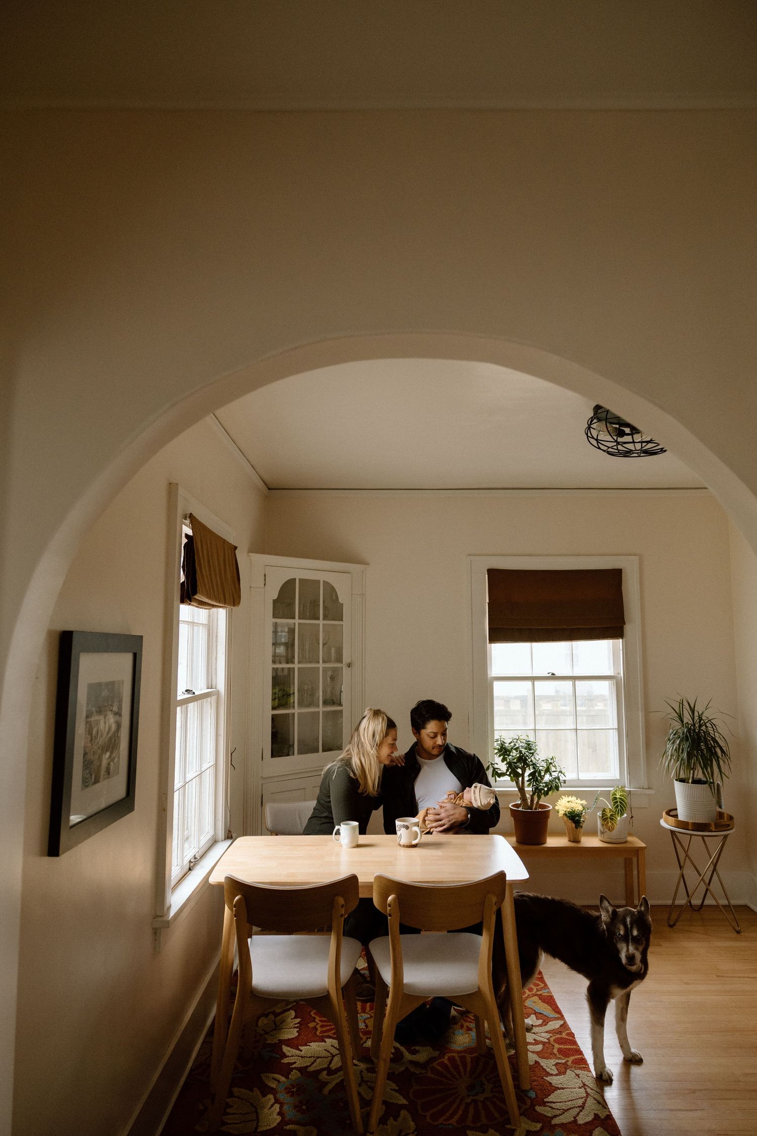 Interior home photography session in a bright room with arched doorways.
