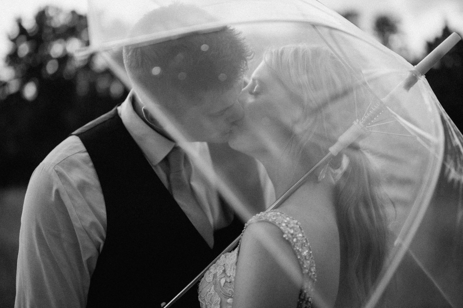 Black and white artistic wedding photography sequence with romantic umbrella silhouettes.