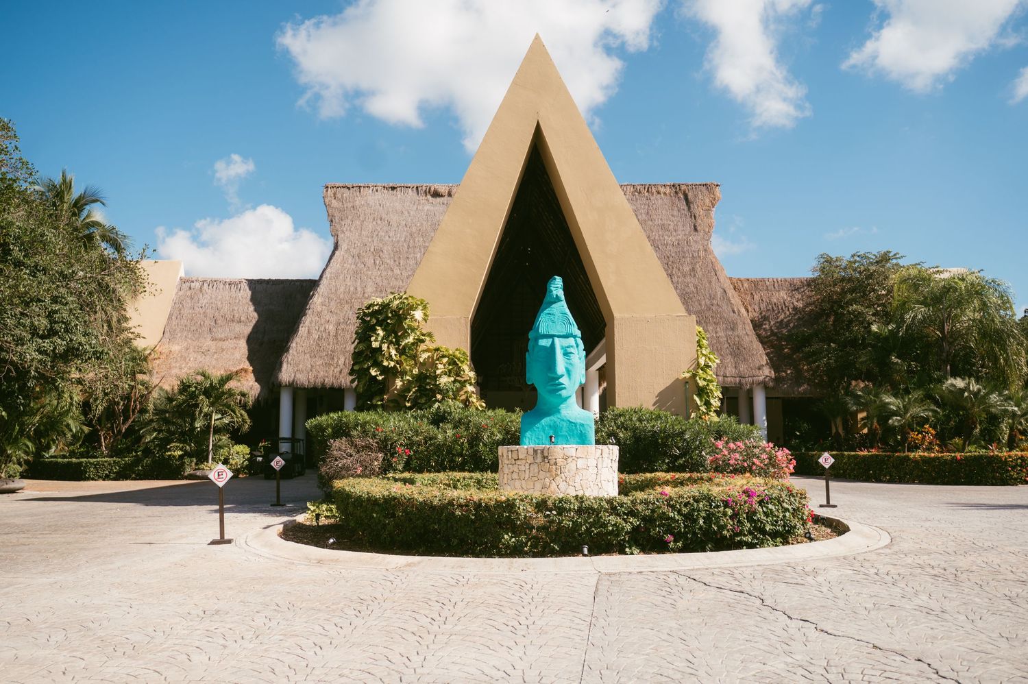 Modern A-frame church or chapel with turquoise doors under blue skies.
