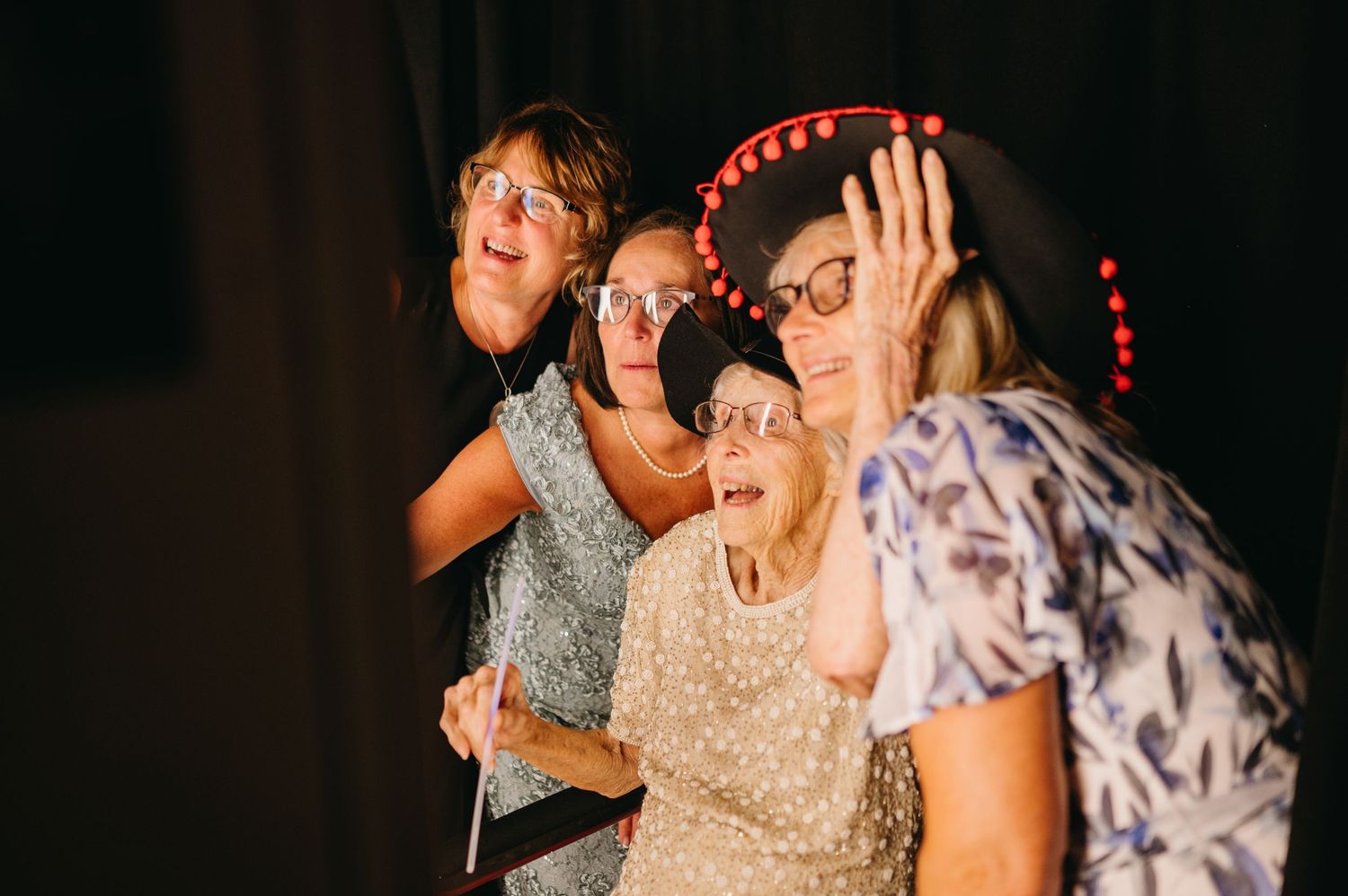 People dancing and celebrating together at an evening indoor reception party.