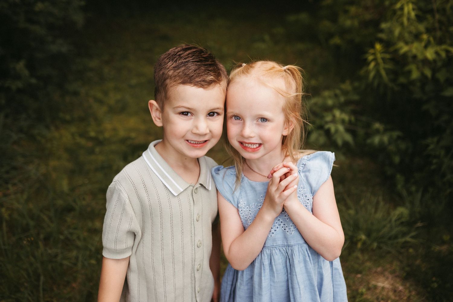 Two children share a playful moment together in nature.