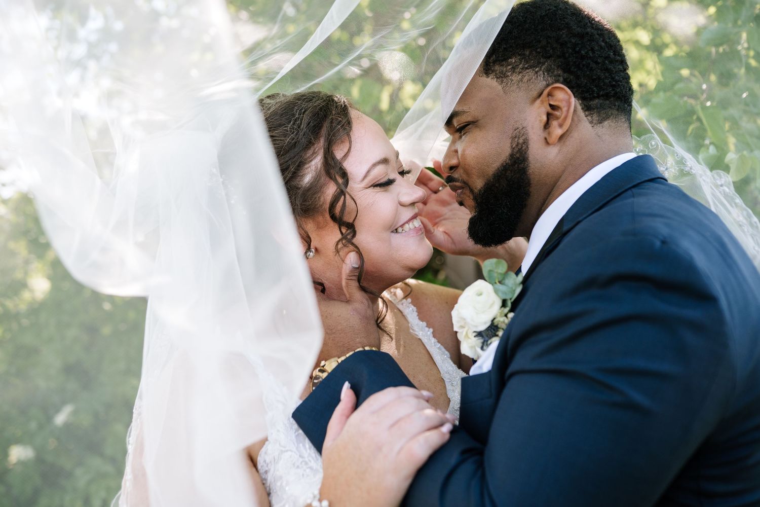 Romantic wedding couple sharing intimate moment outdoors.