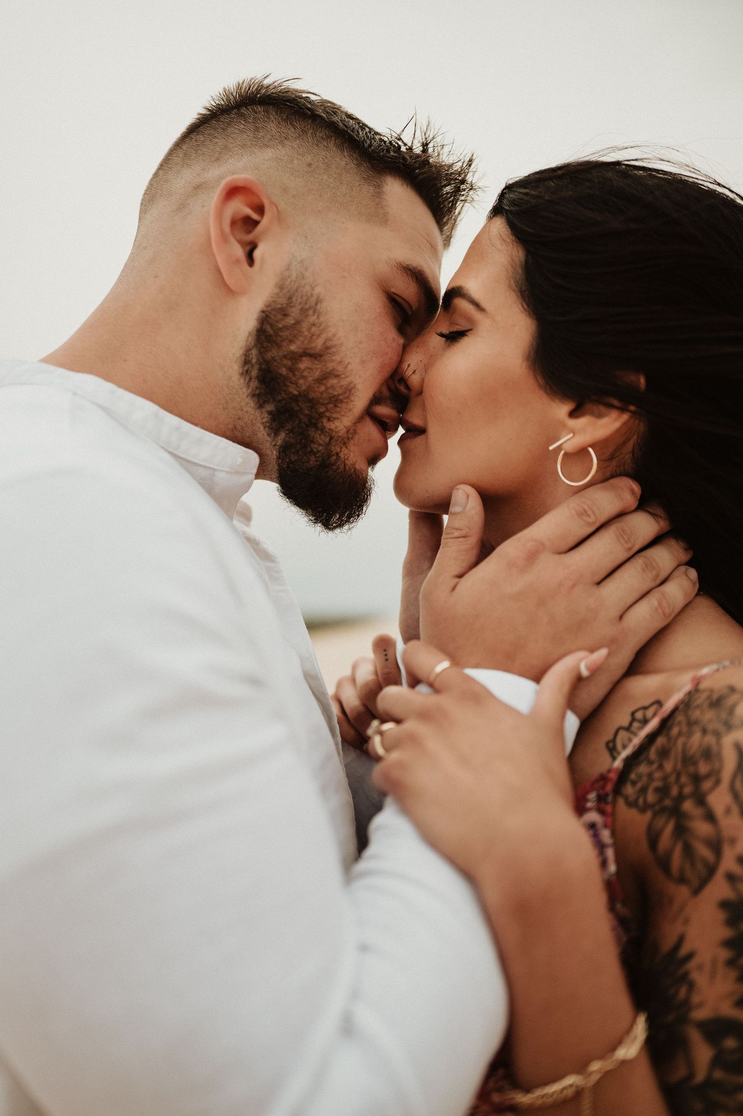 A tender moment between a couple in desert engagement photos showing gentle intimacy and love.