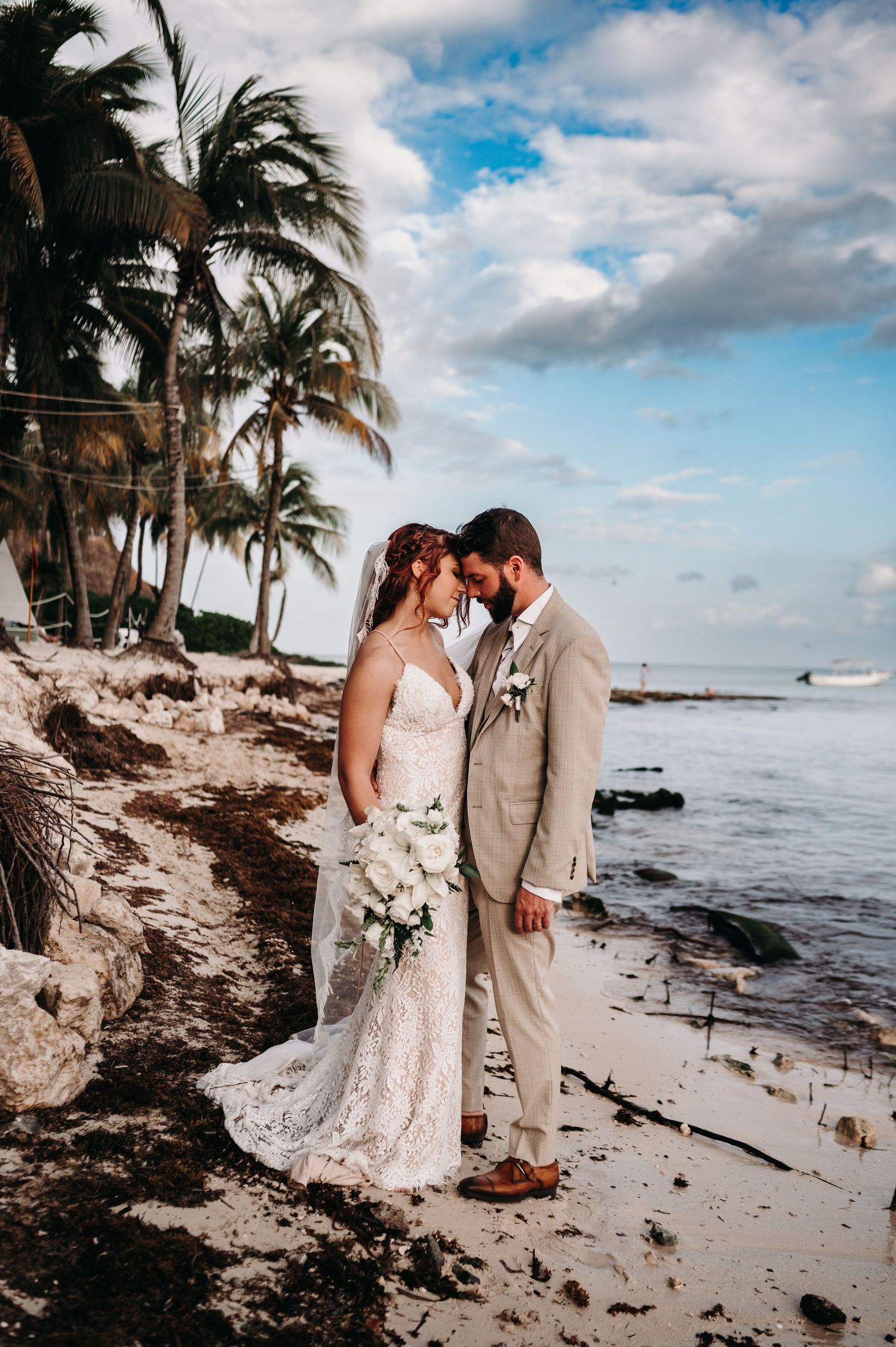 Romantic beach wedding scene with palm trees and ocean waves.