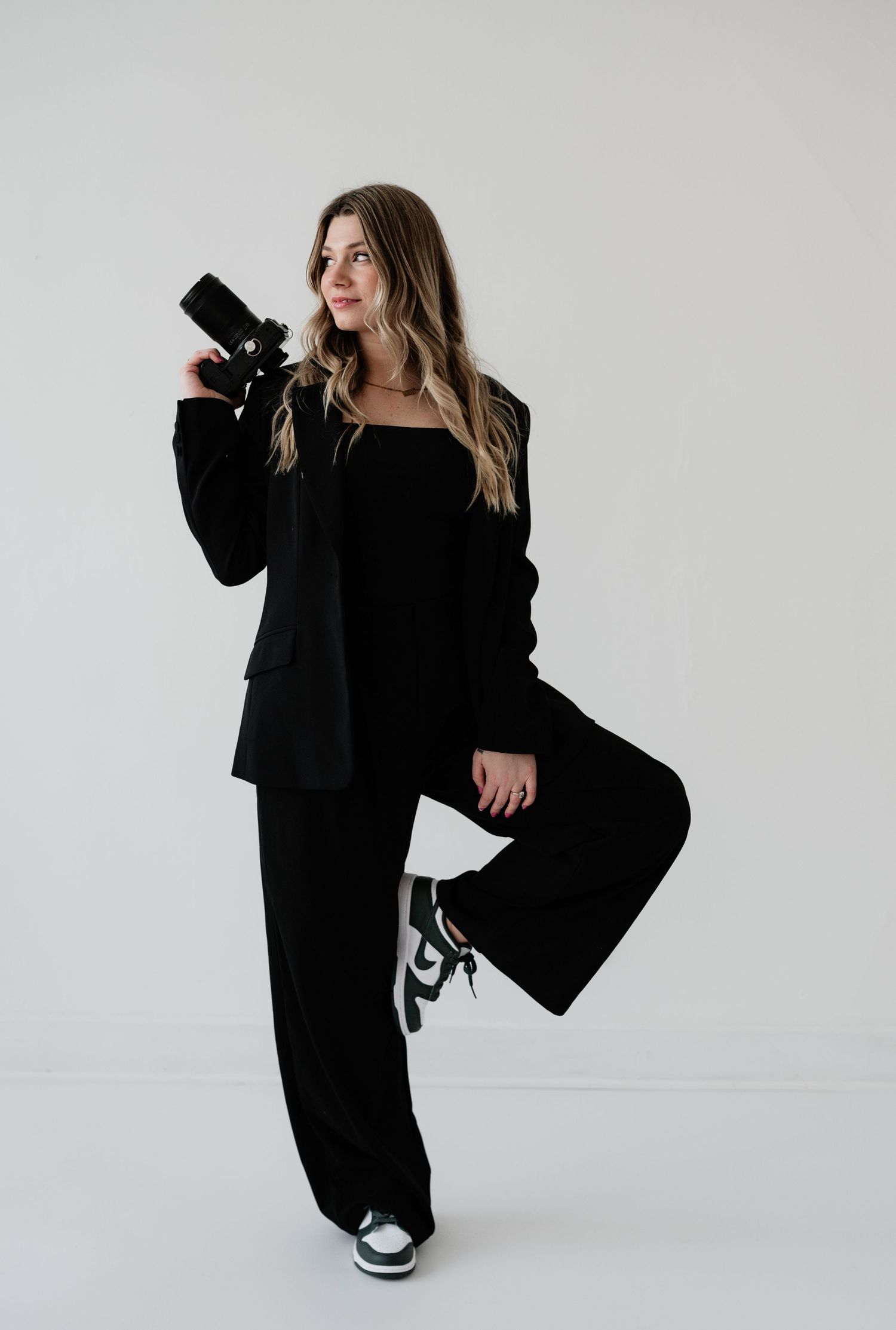 Fashion photography series featuring dramatic poses in black clothing against white backdrop.