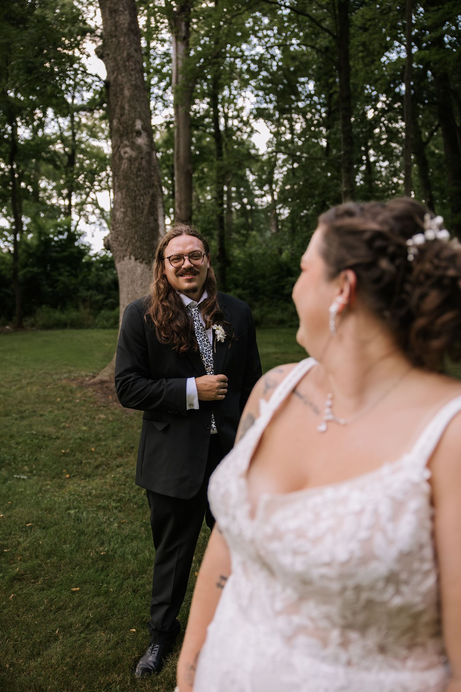 Wedding couple sharing joyful laughter during outdoor photo session.