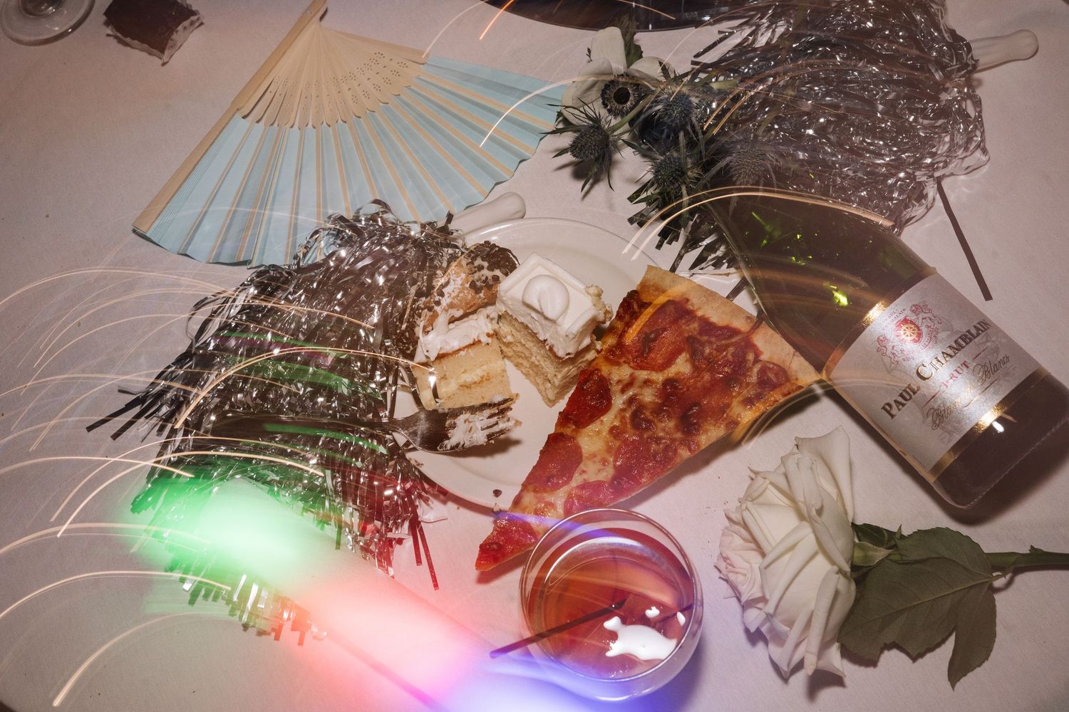 Colorful party decorations and props laid out on a dark surface.