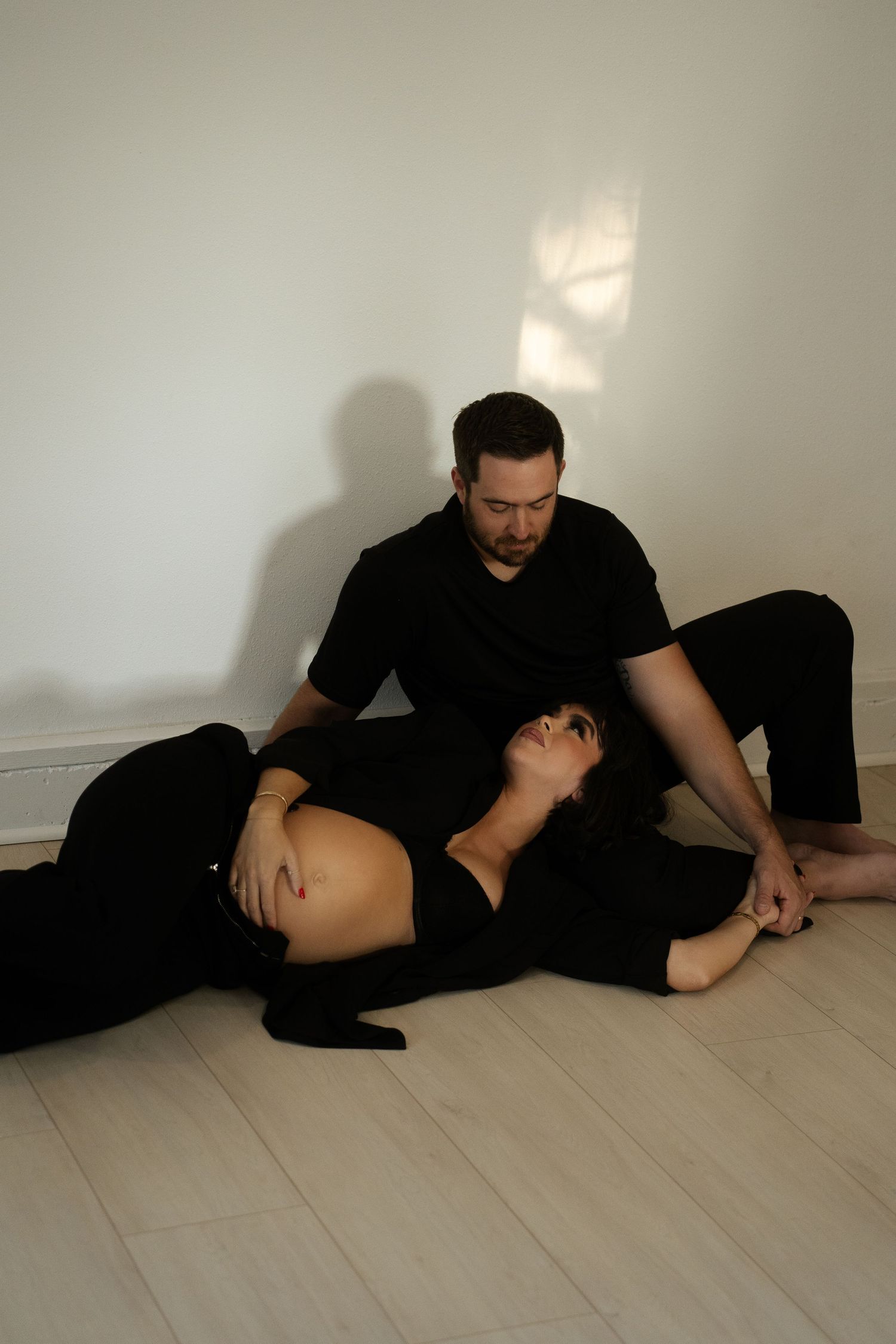 Series of artistic poses on light wooden flooring.
