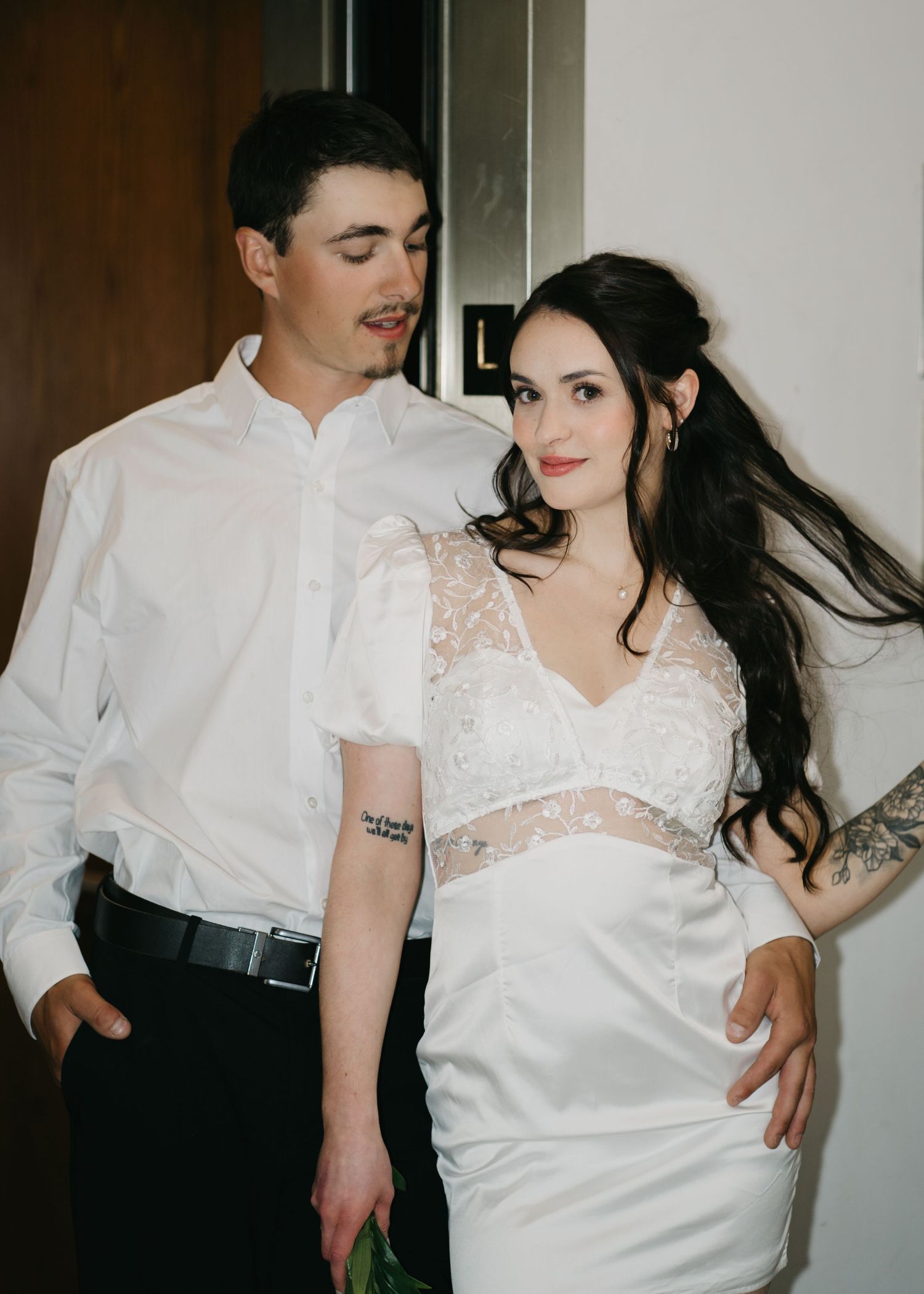 Intimate wedding portrait series showing couple in white against dark background.
