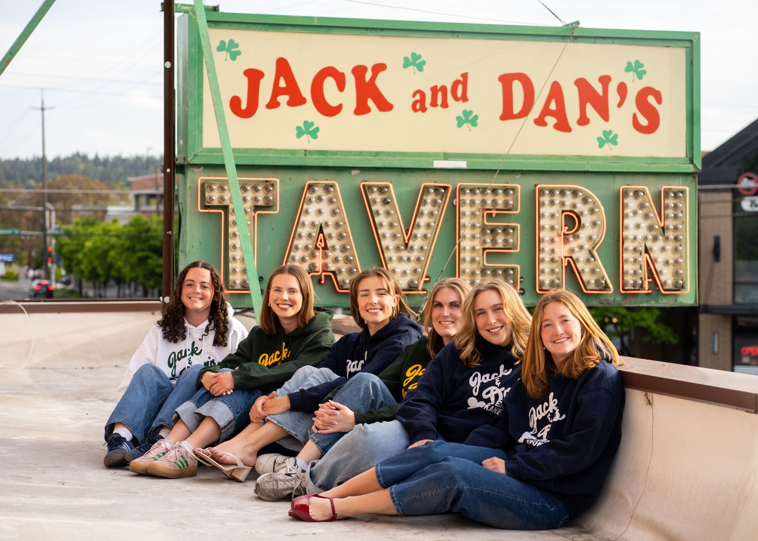 Group photo against a vintage storefront sign.
