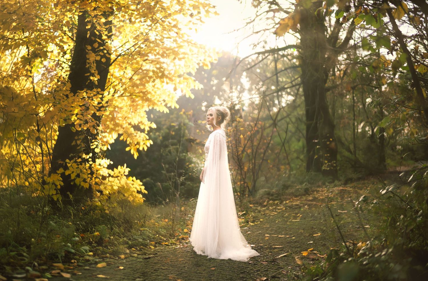 Bride standing in dress looking up at a Hertfordshire wedding