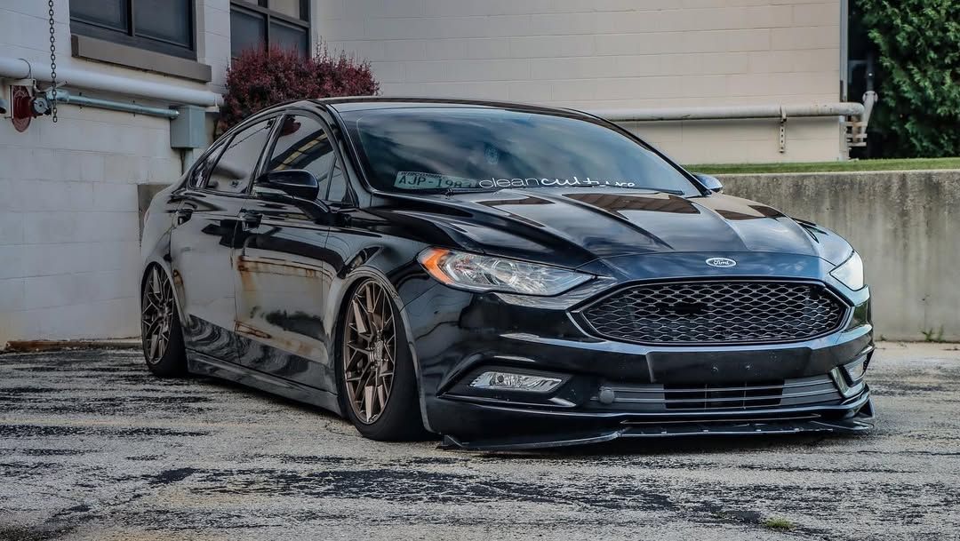 Black 2017 Ford Fusion equipped with air ride suspension laid out on concrete.