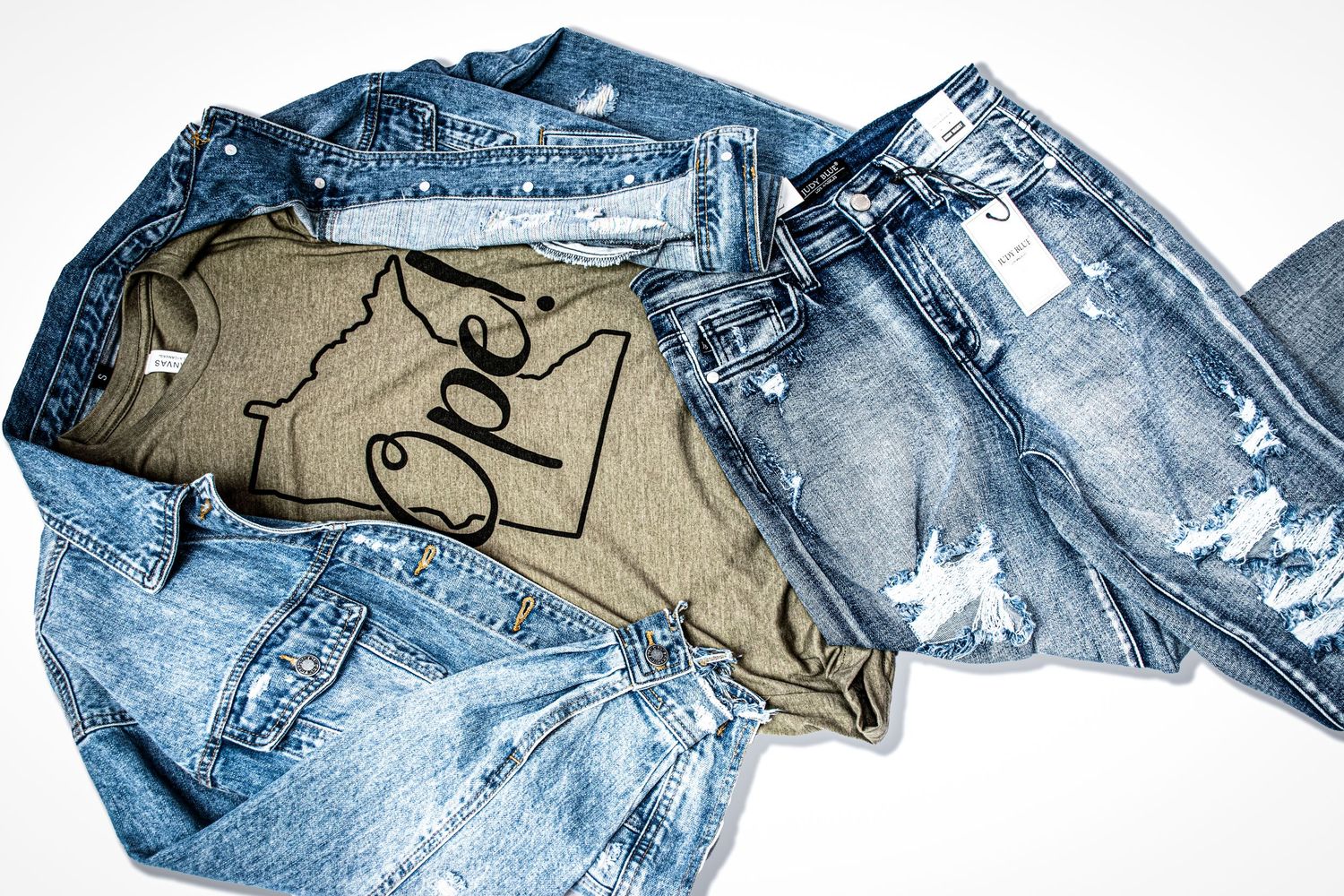 Distressed denim jacket and ripped jeans with olive Oregon state graphic tee on white background at Bee Balm Boutique.