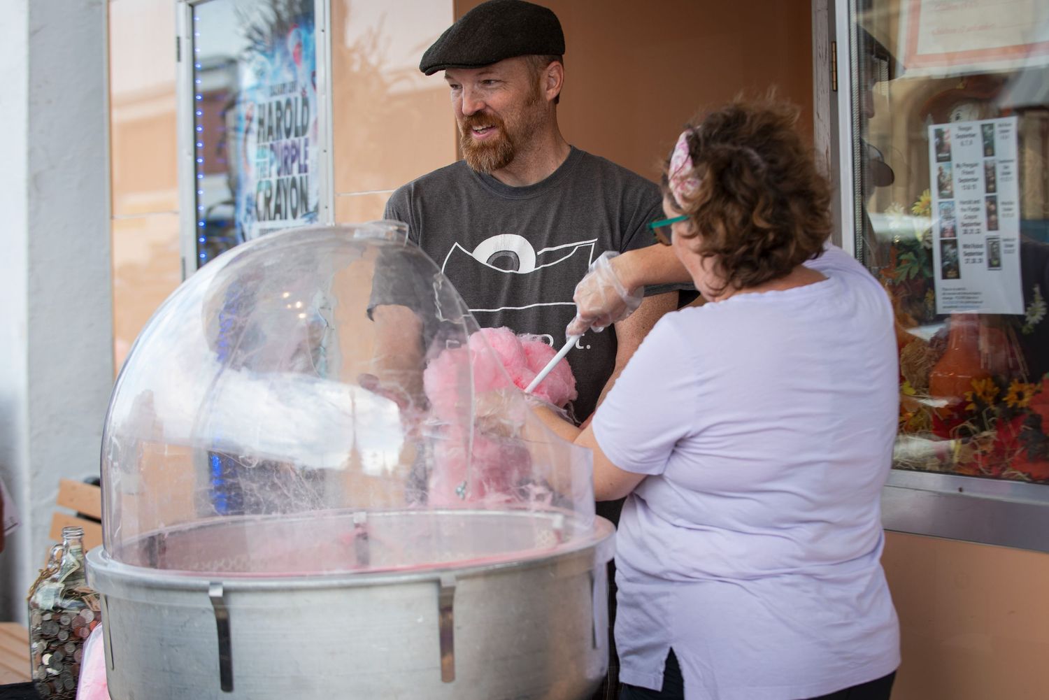 Man and woman making cotton candy outside The Jem theatre in Harmony MN.