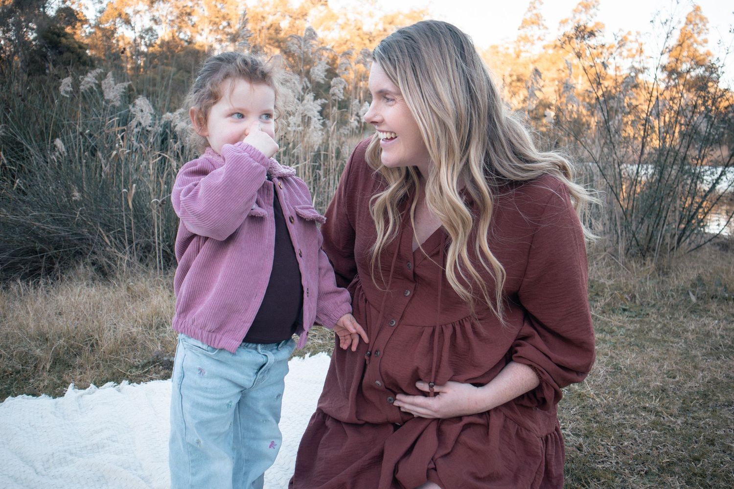 Candid toddler moment during family session exploring nature outdoors