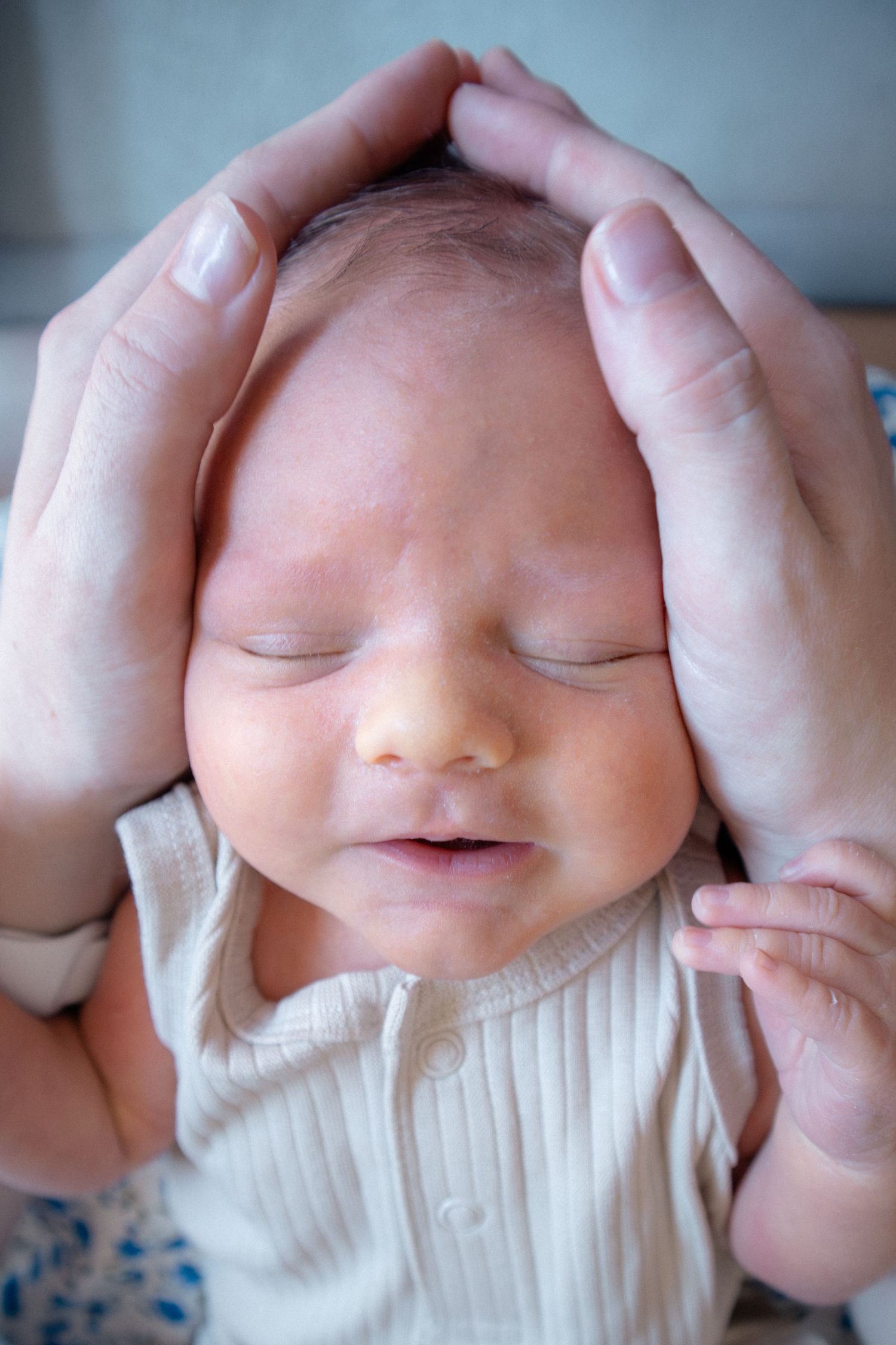 Close-up newborn portrait showing soft skin tones and peaceful expression