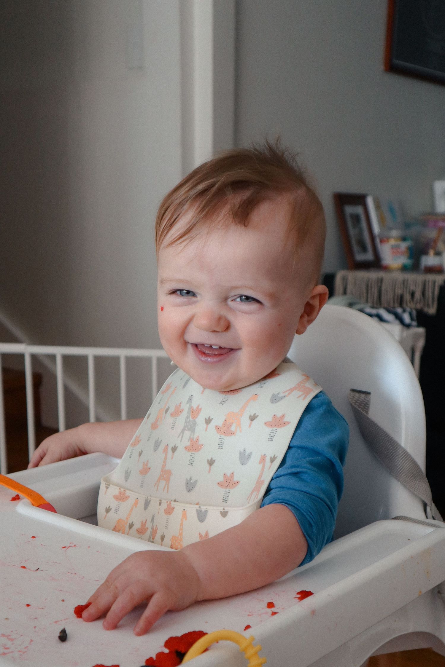 Baby smiling in high chair during candid lifestyle family moment at home