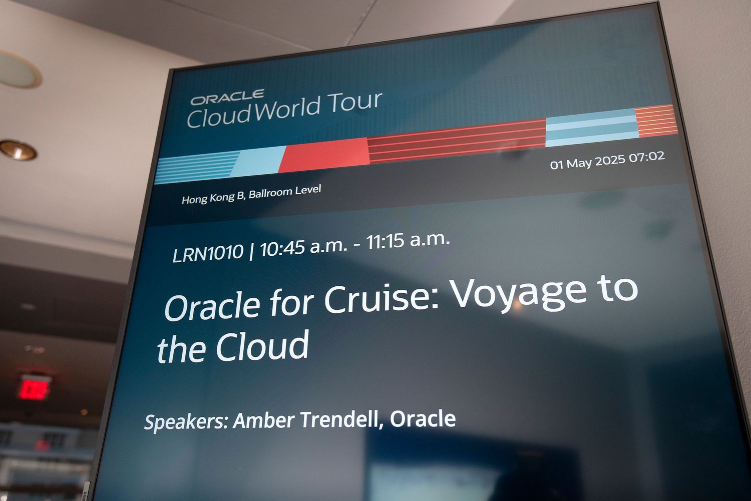 Oracle CloudWorld Tour sign displaying session LRN1010 Oracle for Cruise: Voyage to the Cloud at Hong Kong Ballroom.