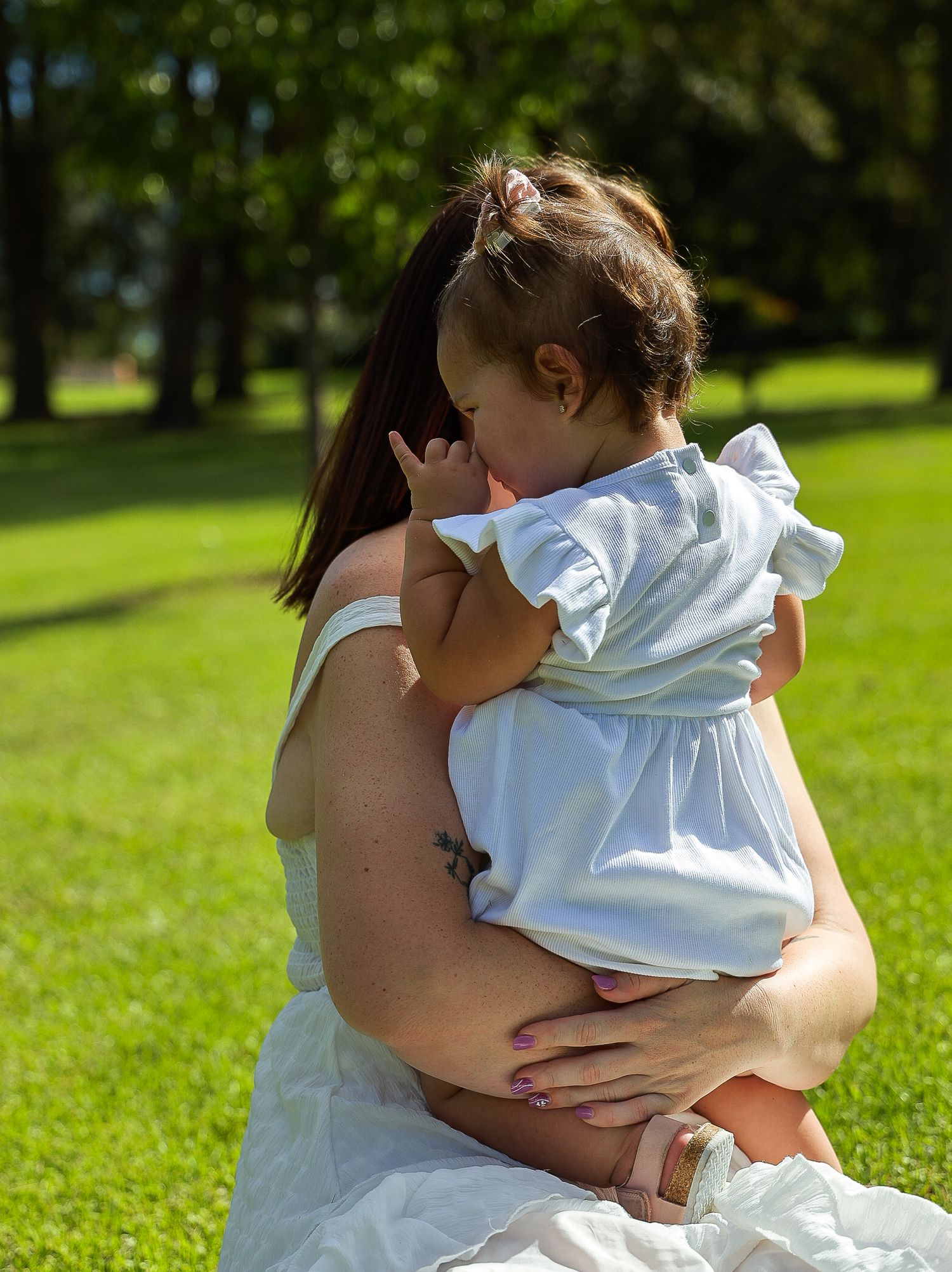 A young girl in her mothers arms