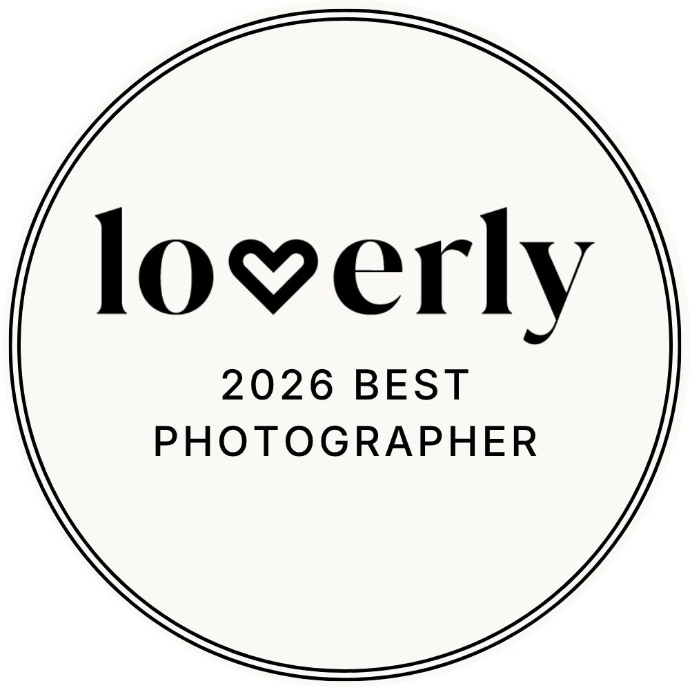 Loverly 2026 Best Photographer award badge, a circular black and white seal with a heart logo.