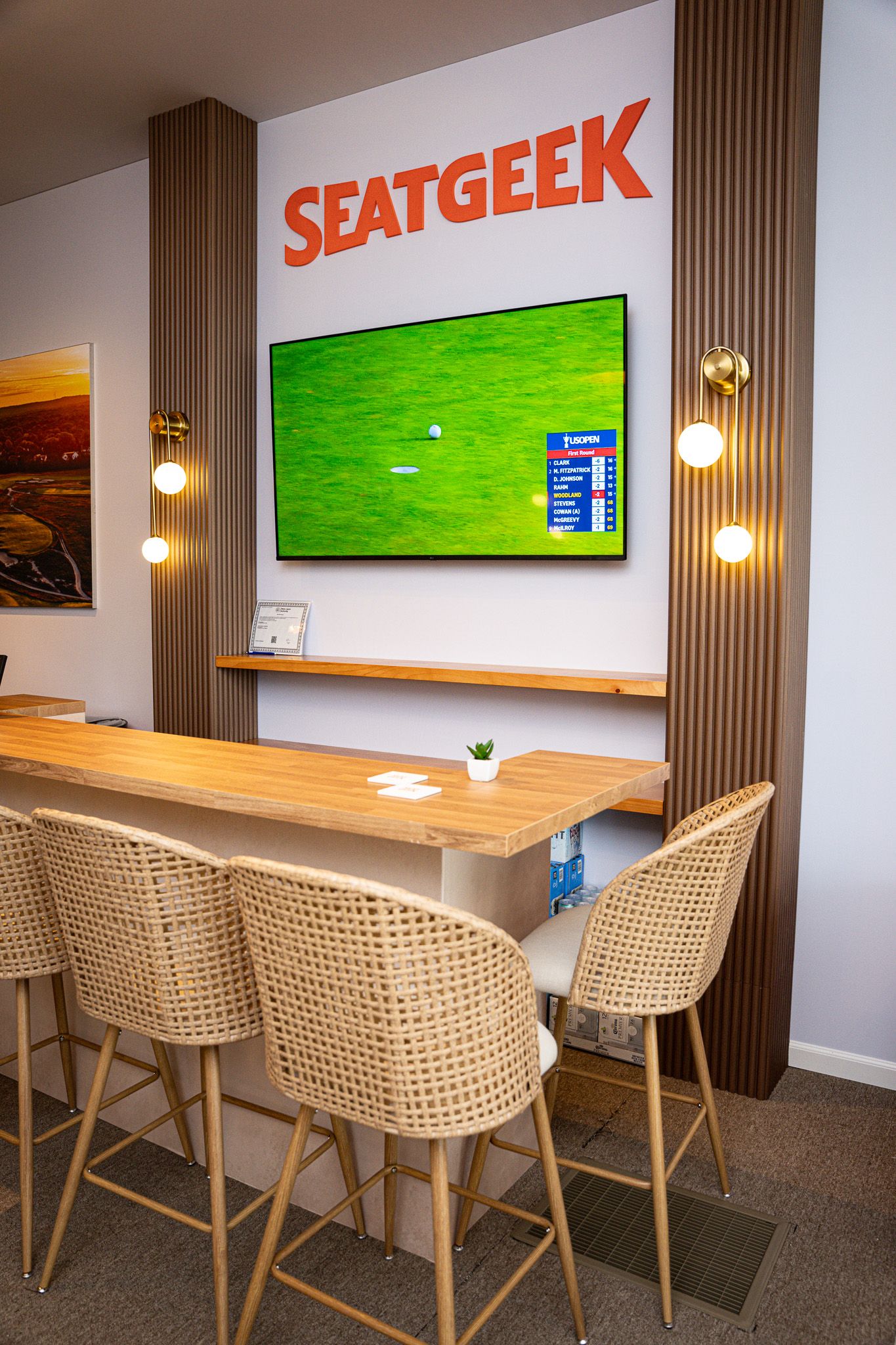 Corporate event photography of a company suite at the U.S. Open Golf Championship in the Hamptons, NY featuring a  modern bar and TV