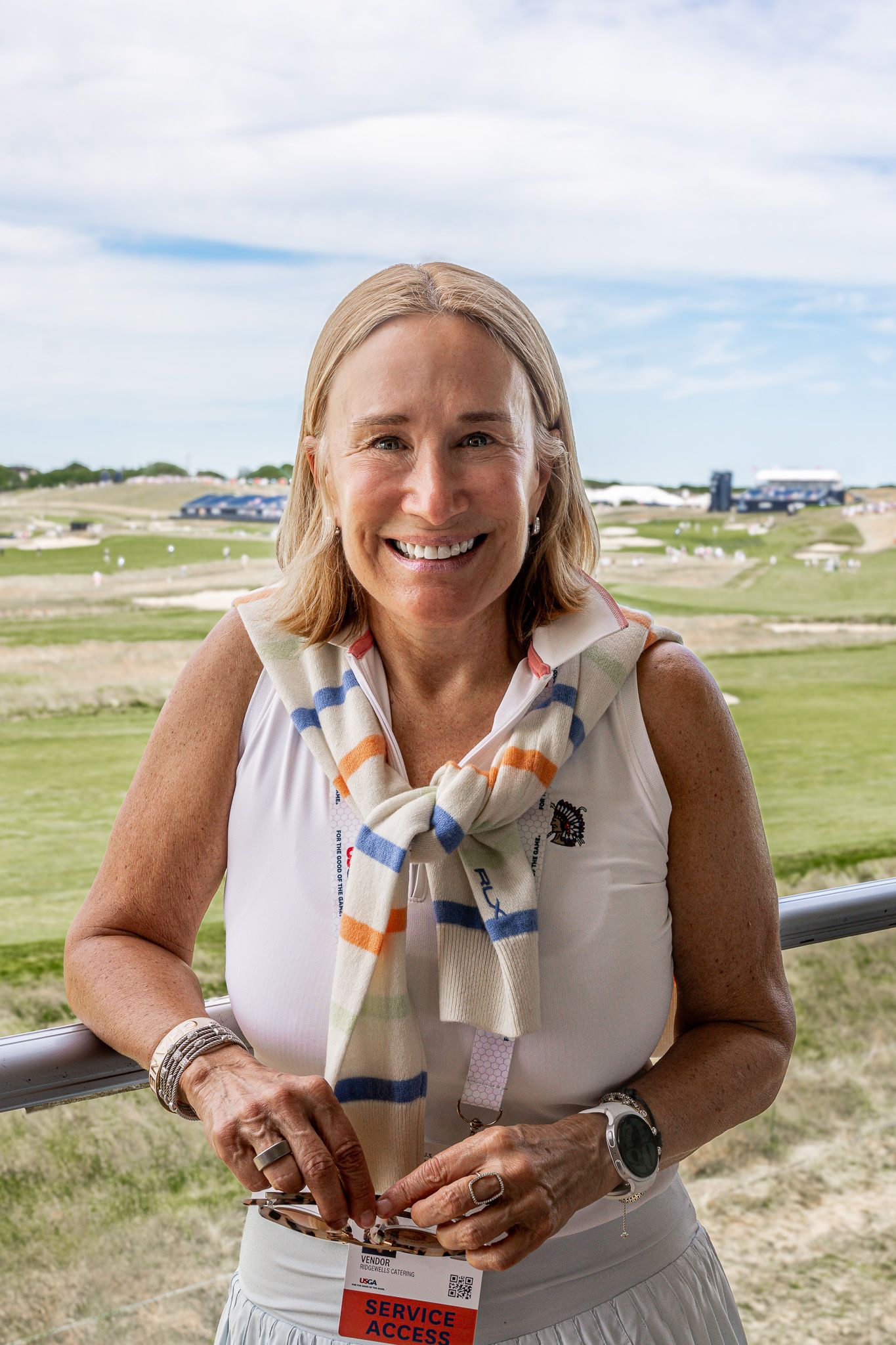 A headshot of a female CEO inside a luxury suite at the U.S. Open Golf Championship at Shinnecock Hills, The Hamptons, New York.