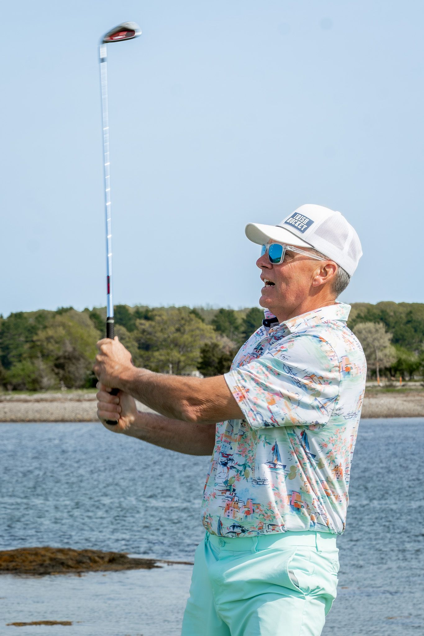 Event photography of a man swinging his golf club during a charity fundraiser golf tournament at Wentworth by the Sea Country Club.