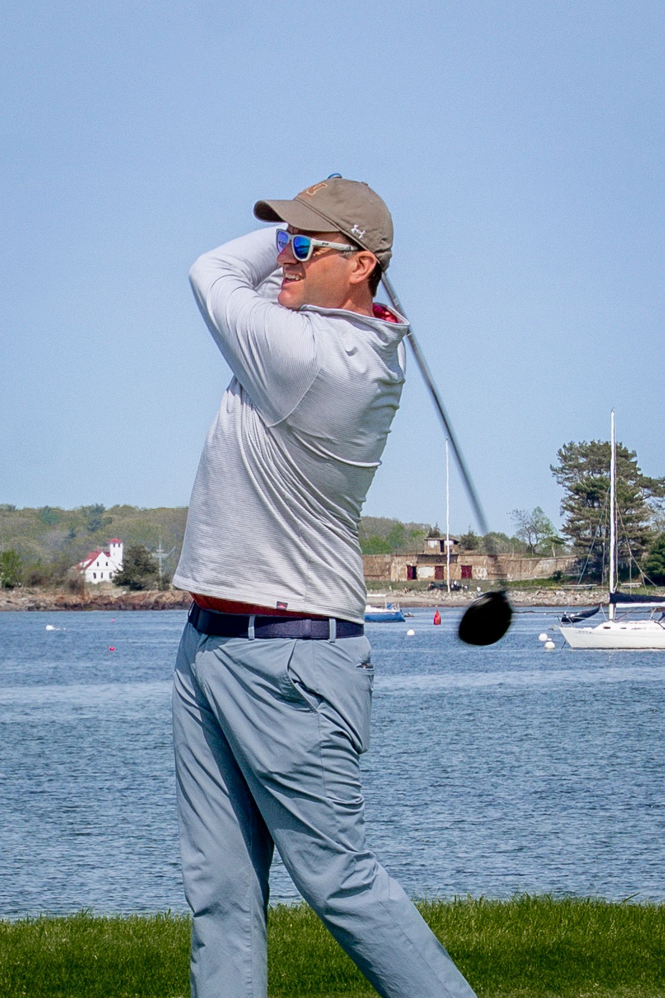 Event photography of a man swinging his golf club during a charity fundraiser golf tournament at Wentworth by the Sea Country Club.