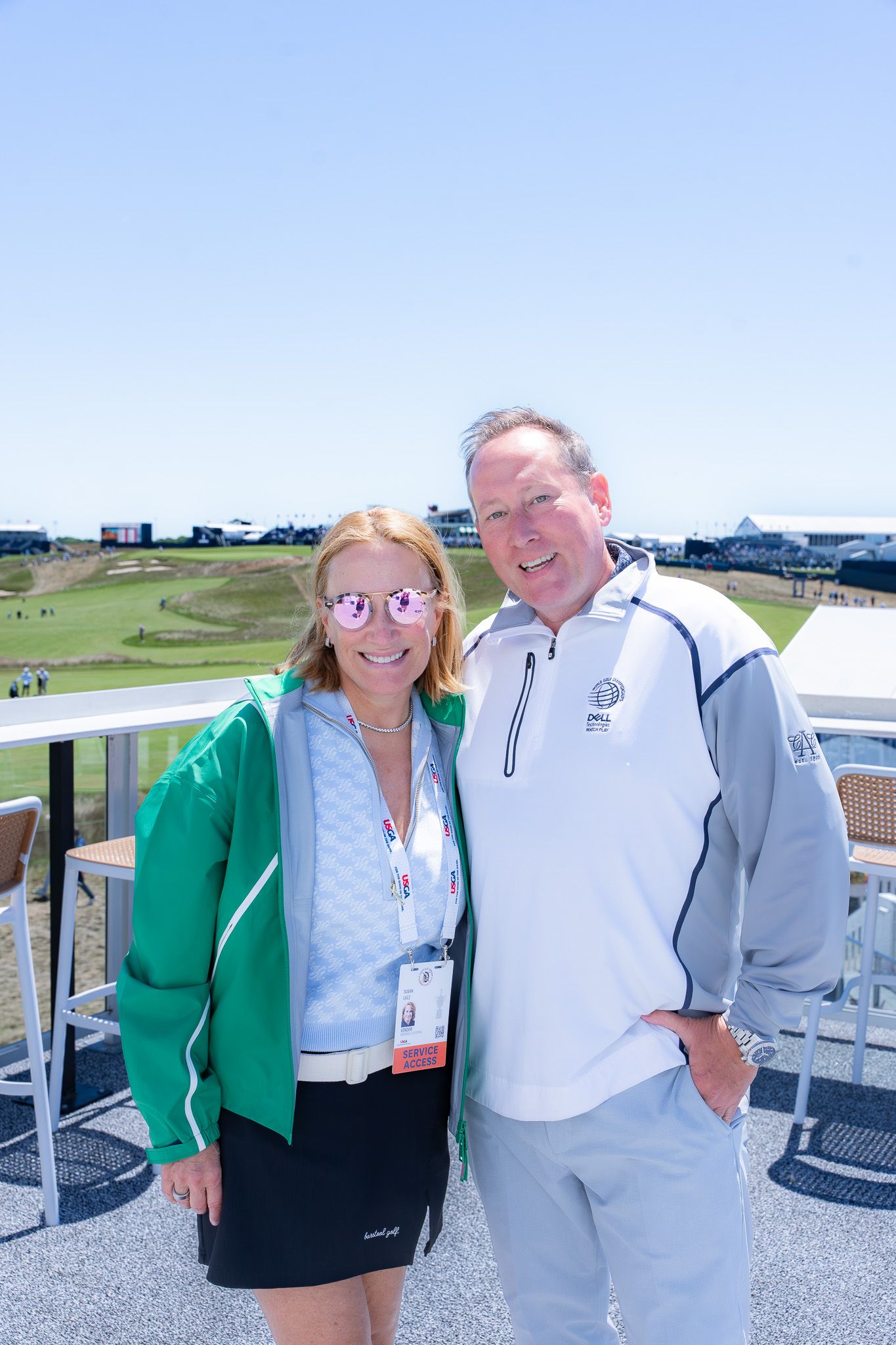 Event photography of a man and woman smiling outside of a luxury suite at the U.S. Open Golf Championship in the Hamptons, New York.