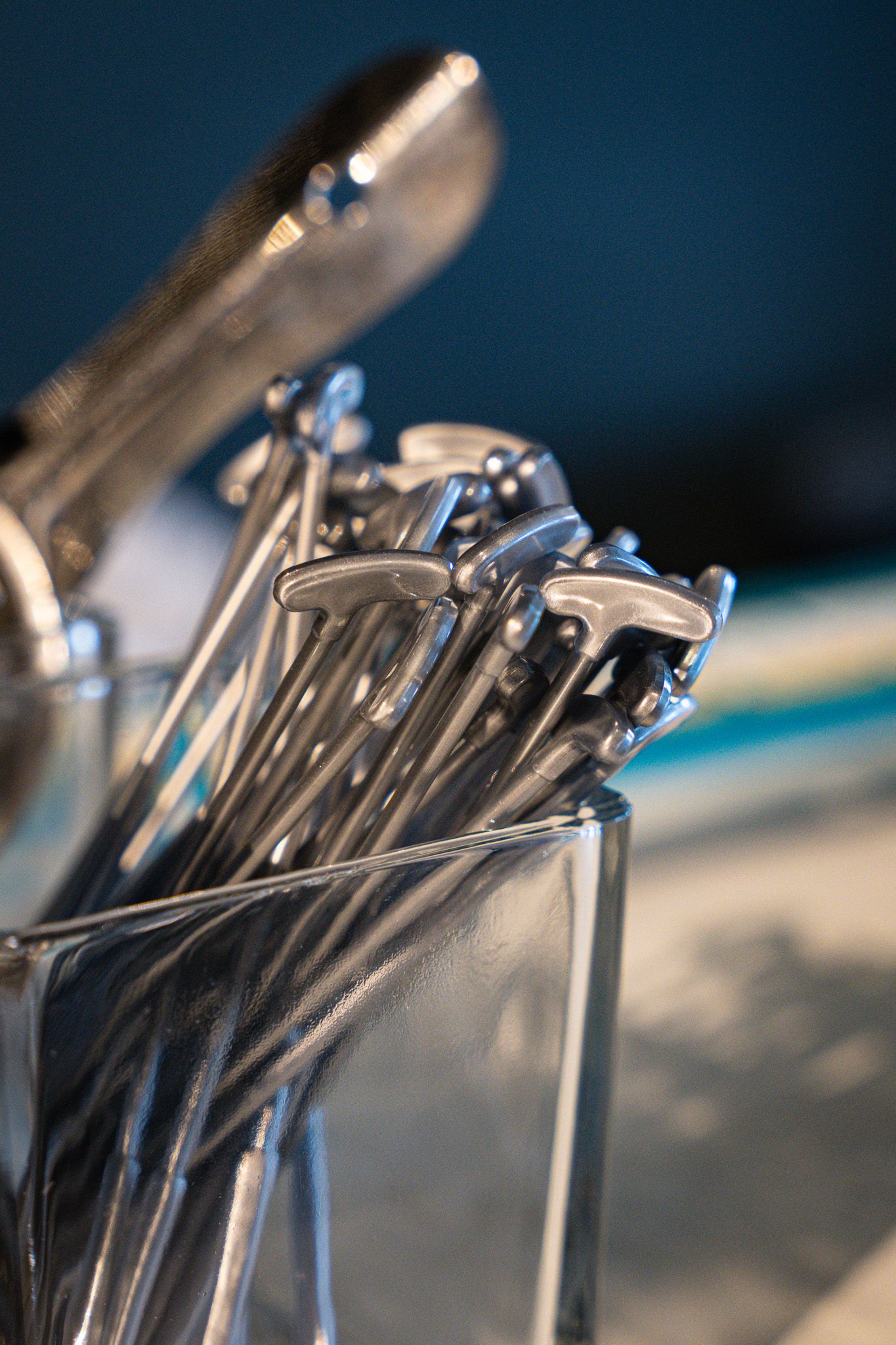 A closeup of silver golf tee cocktail picks in a glass vase for a corporate event in the Hamptons, New York