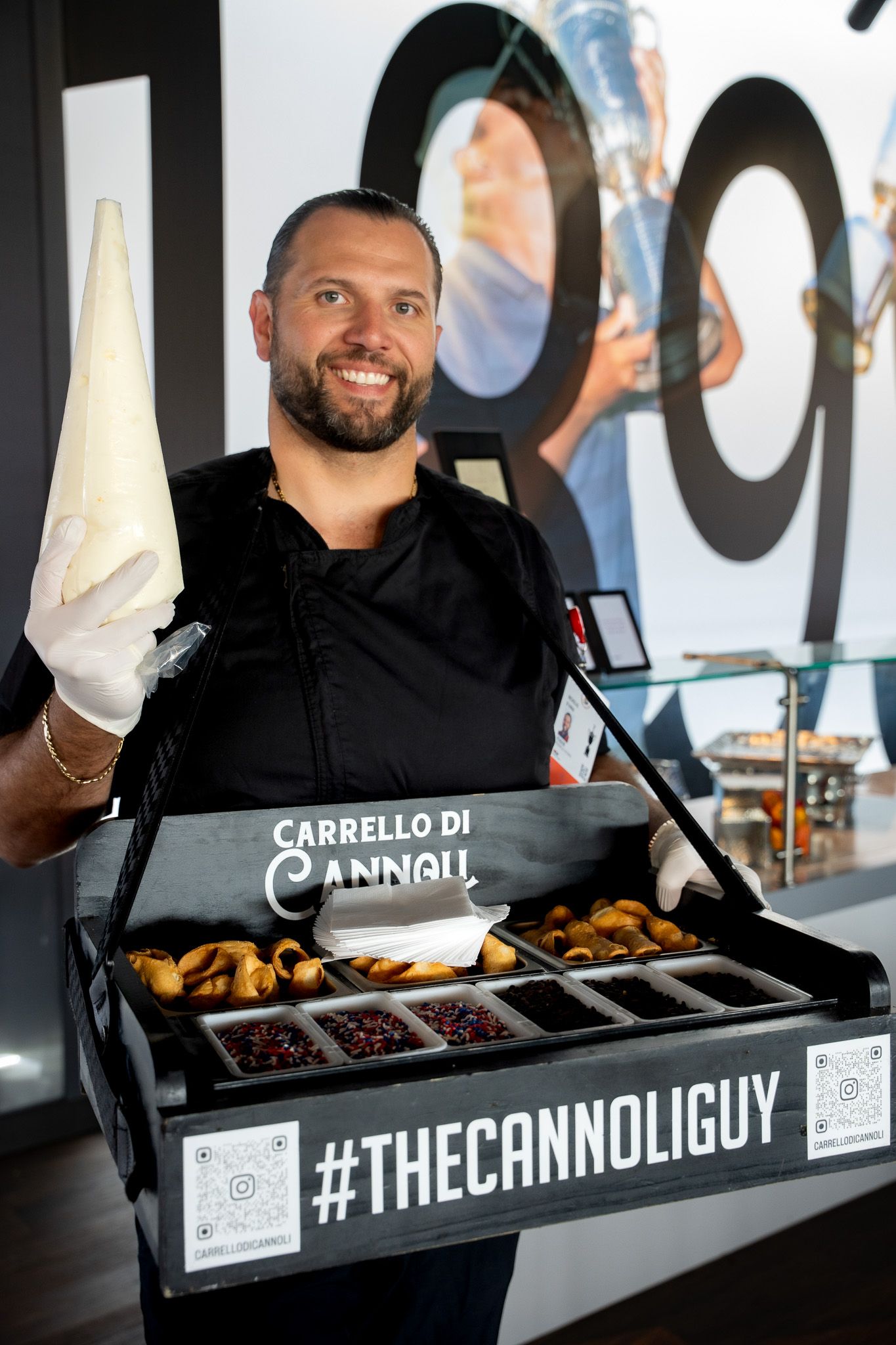 Event photography of a man wearing a hawker tray making cannolis in the 1895 club at the U.S. Open Golf Championship in the Hamptons, NY