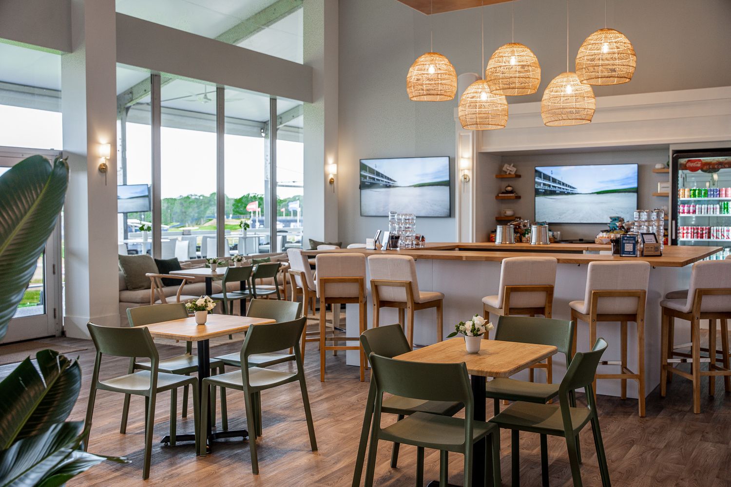Corporate event photography of a company suite at the U.S. Open Golf Championship in the Hamptons, NY featuring a modern clean white bar