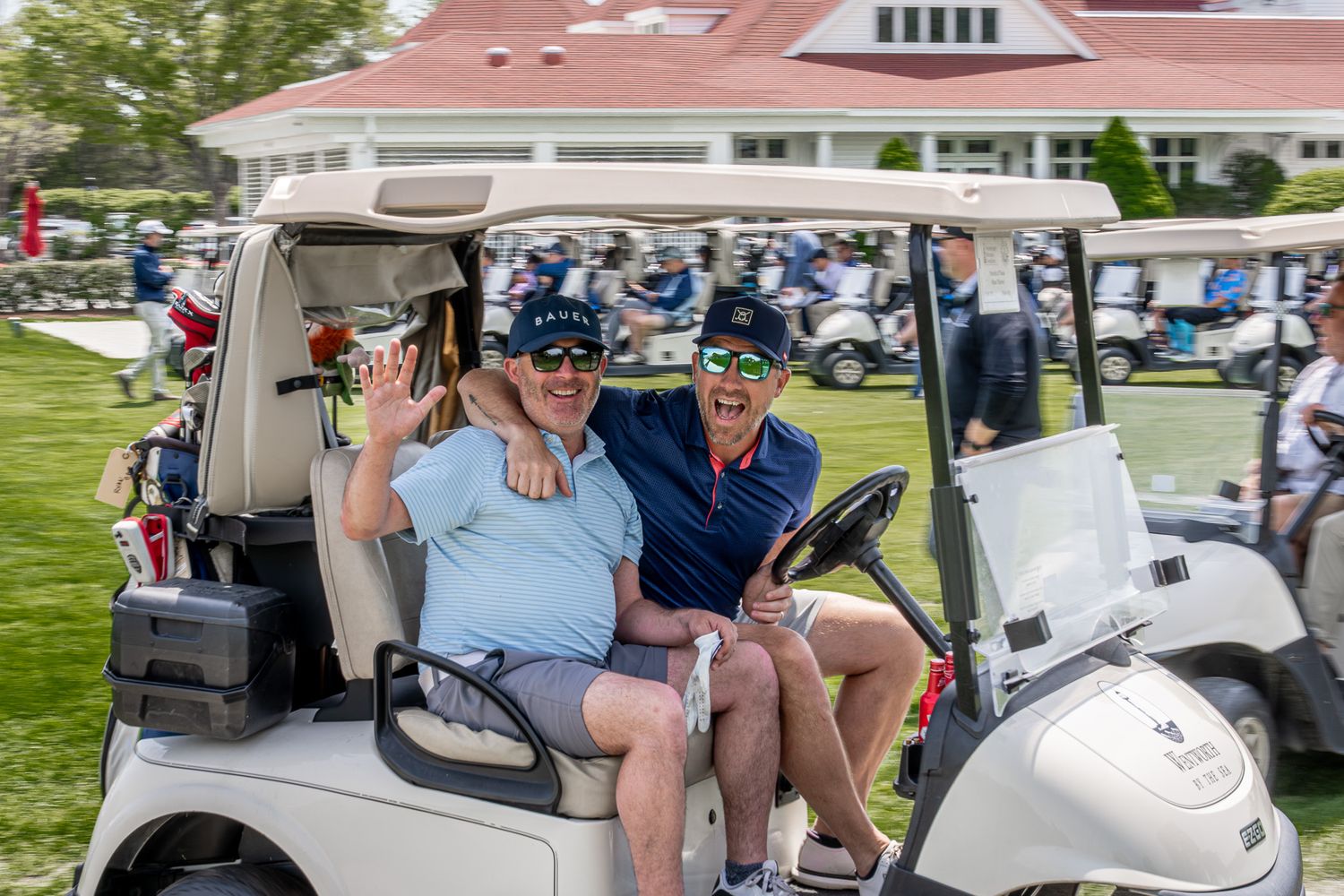 Event photography of two men on a golf cart at a charity tournament at Wentworth by the Sea Country Club in Portsmouth, New Hampshire.