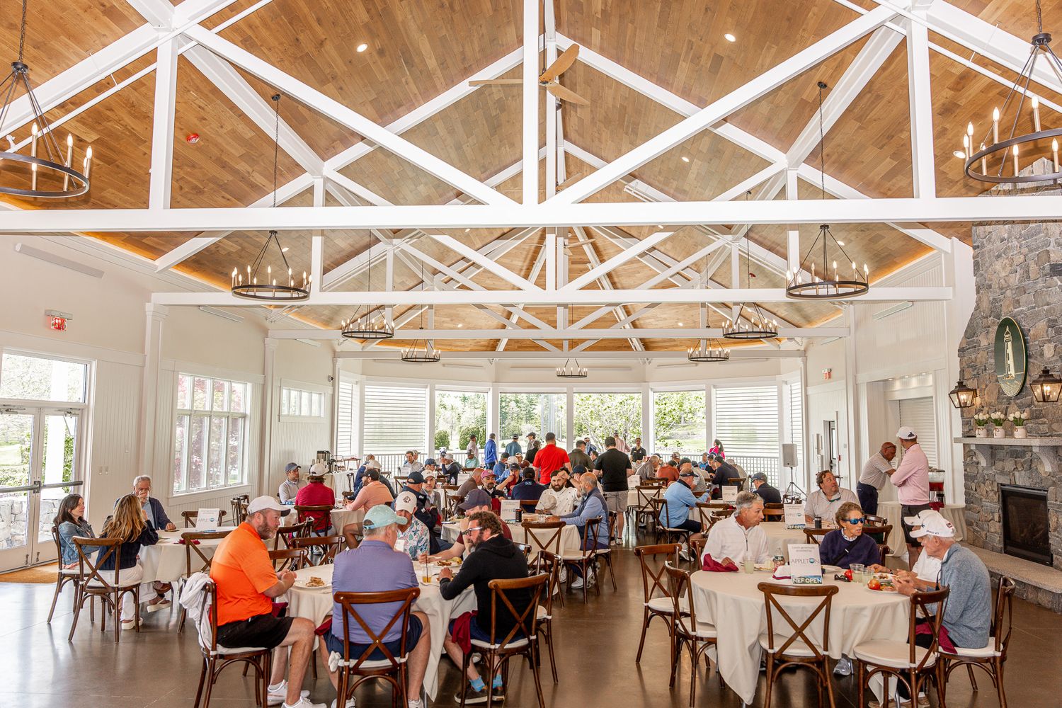 Event photography of a beautiful room of people seated at a non-profit fundraiser at Wentworth by the Sea in Portsmouth, New Hampshire.