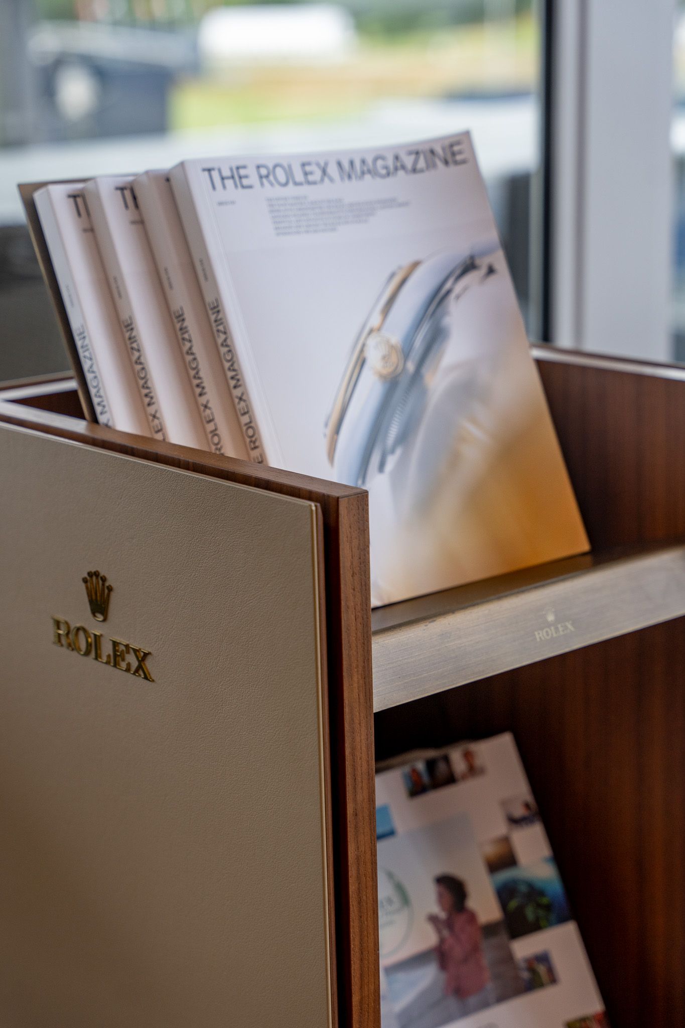Corporate event photography of a company suite at the U.S. Open Golf Championship in the Hamptons, NY featuring a Rolex magazine stand