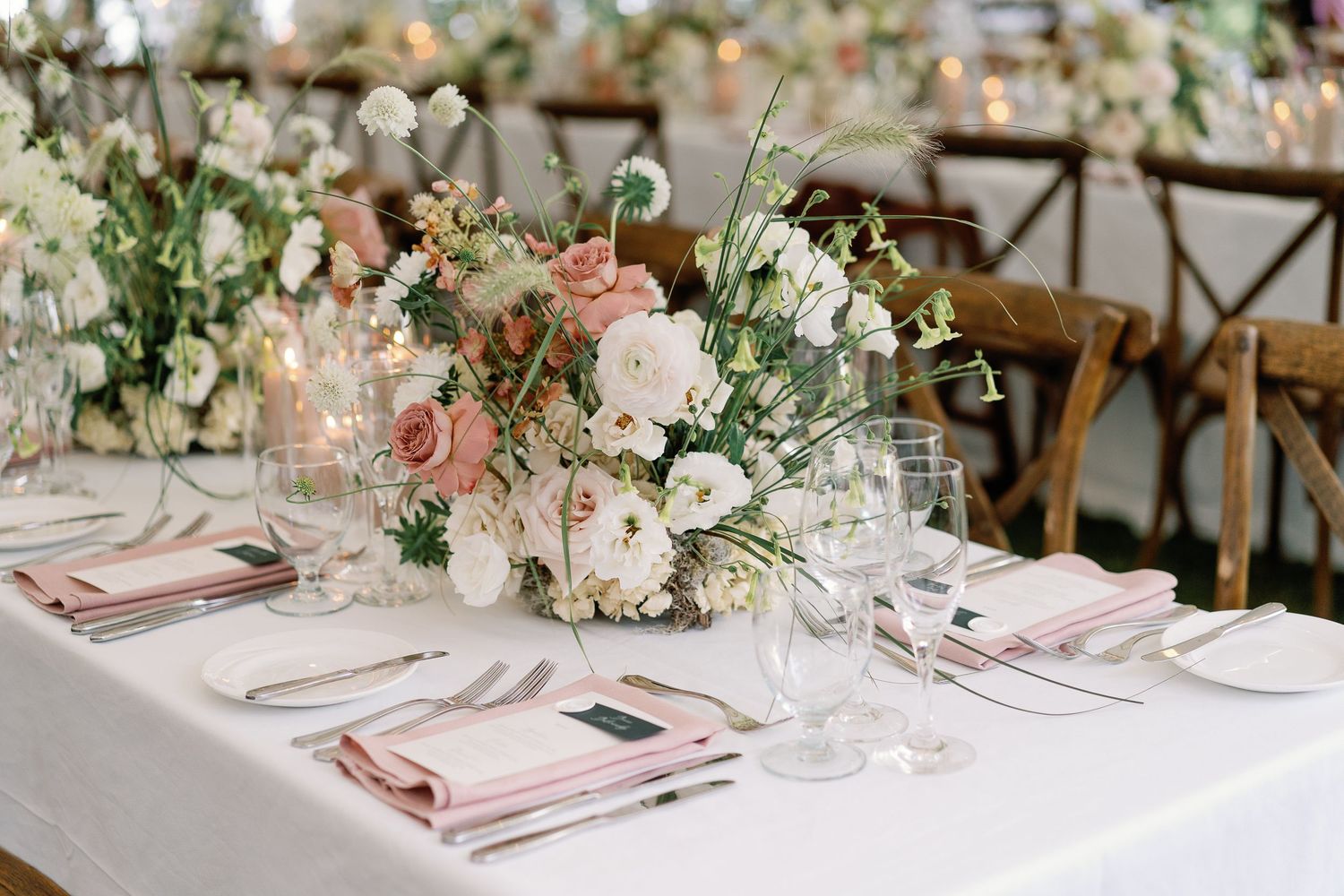 Large rose and peony centerpieces in soft pinks and whites on a table at an elegant coastal wedding in Seacoast, New Hampshire