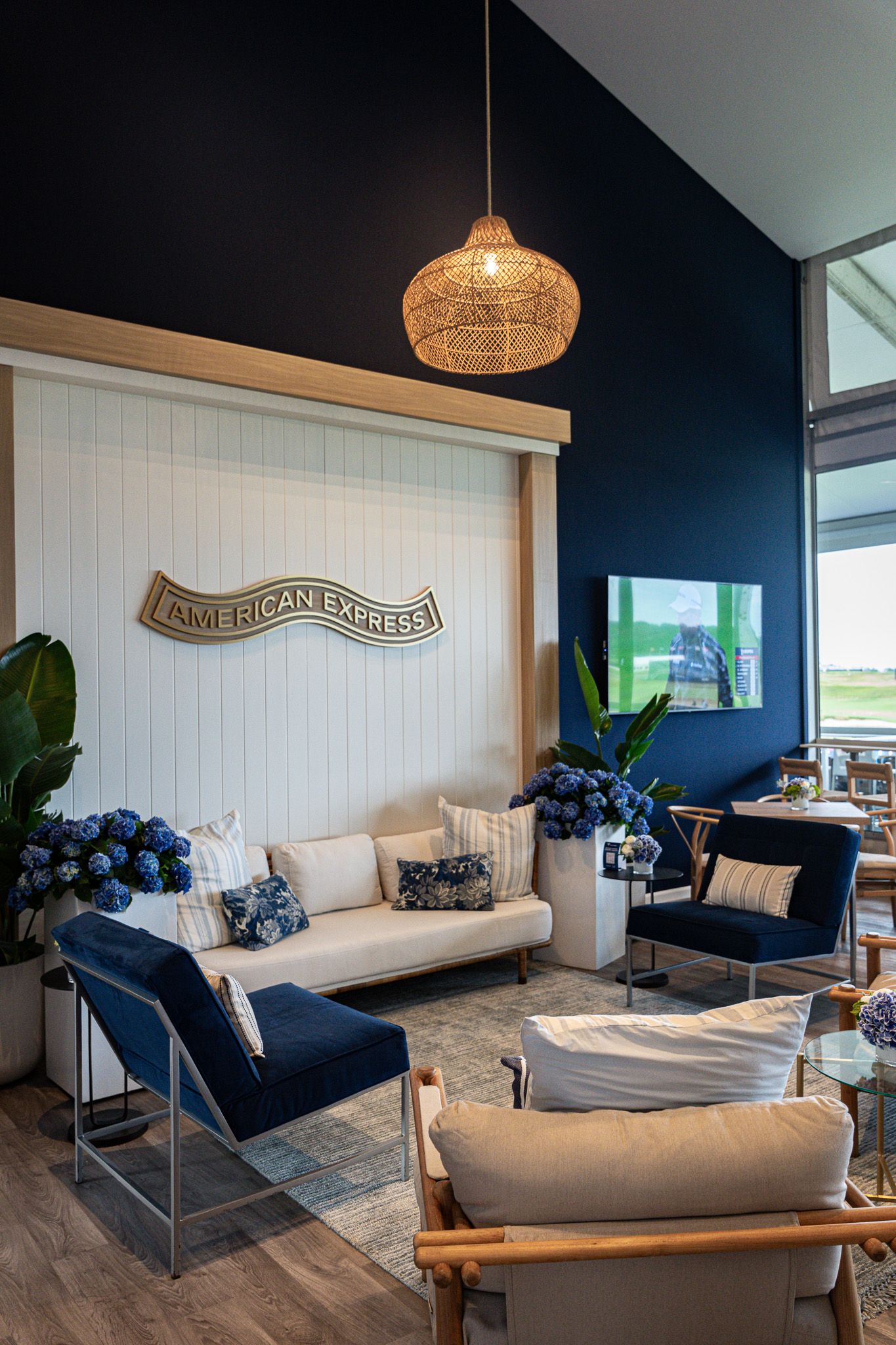 Corporate event photography of a company suite at the U.S. Open Golf Championship in the Hamptons, NY featuring a plush lounger